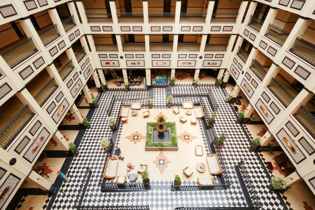 Stylish black and white tiled atrium in Hotel Gold River, a Salou hotel inspired by the far west theme.