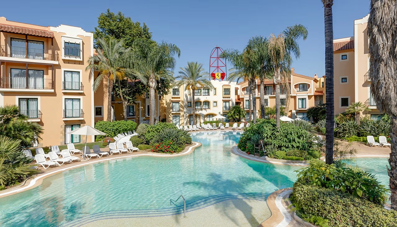 Enjoy a great stay at Hotel PortAventura in Salou, featuring a pool and inviting lounge chairs.