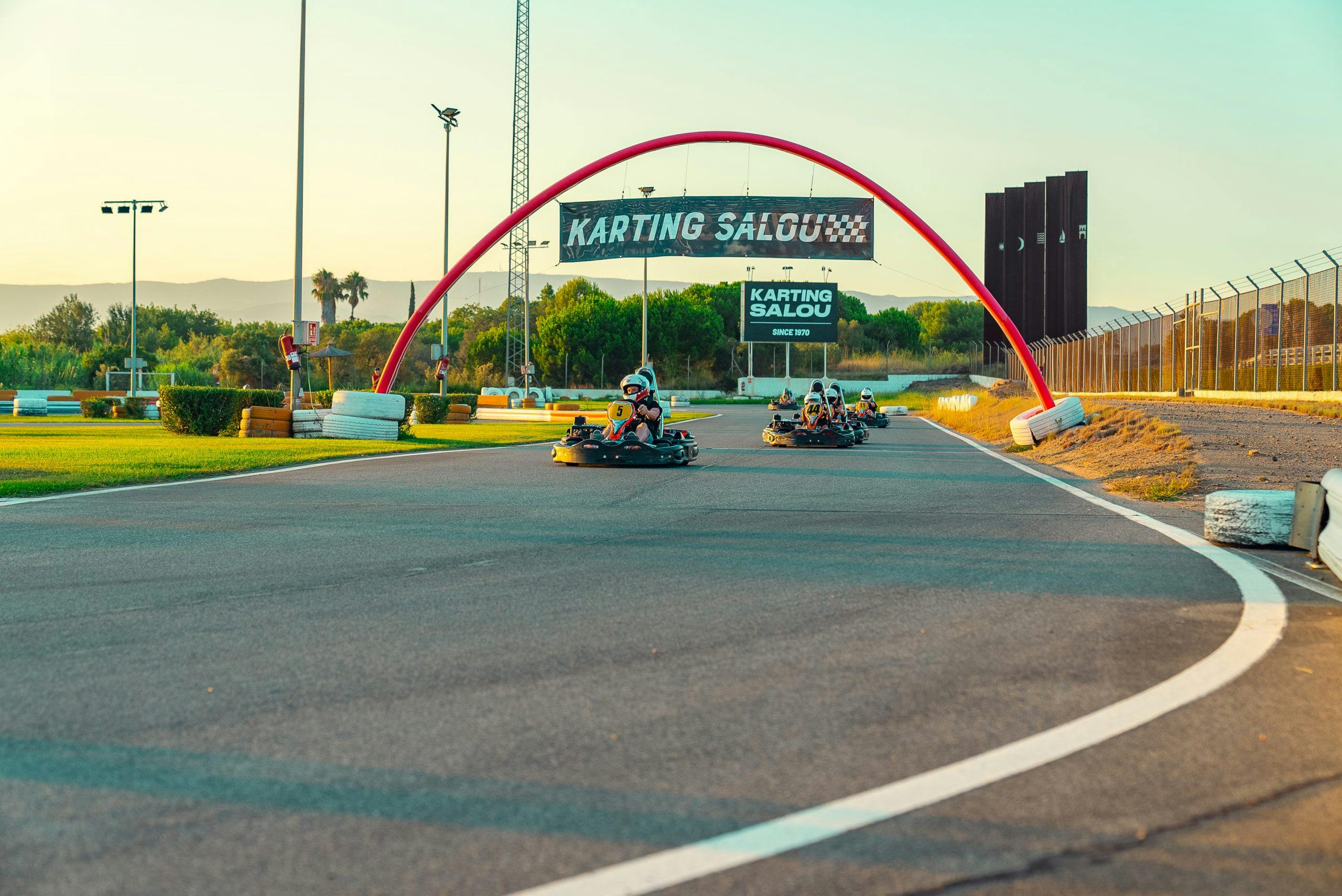 A thrilling race of go-kart drivers speeding down a track, showcasing the excitement of the ride.