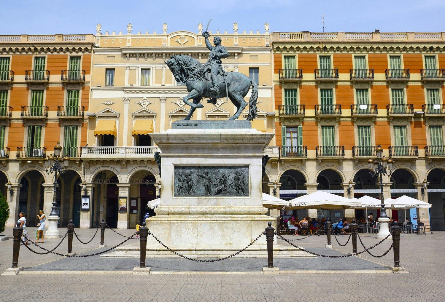 A bronze statue of a man on a horse in Reus, near Salou.