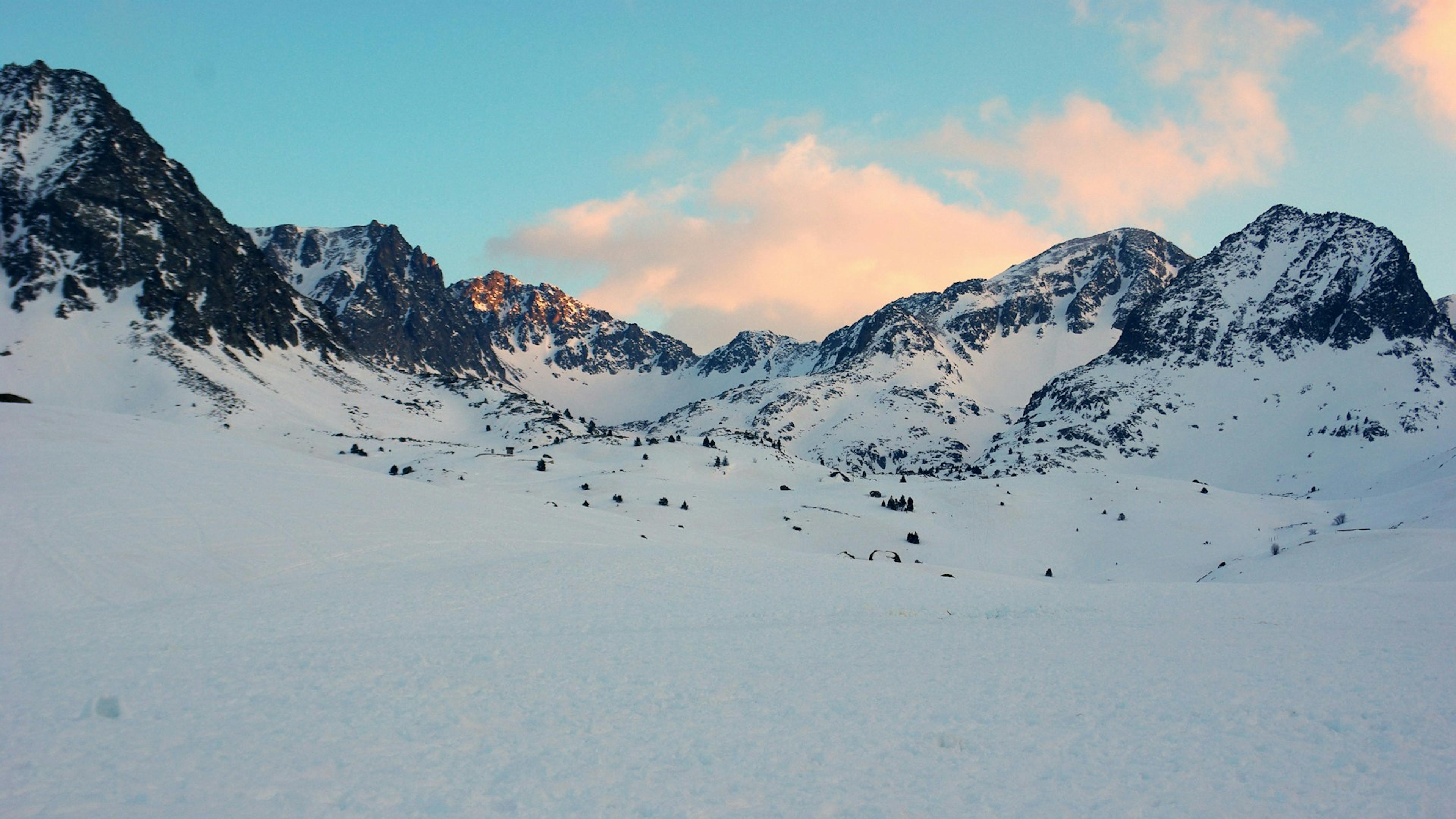 Snowy mountain range with majestic peaks and glistening white slopes, creating a serene and breathtaking winter landscape.