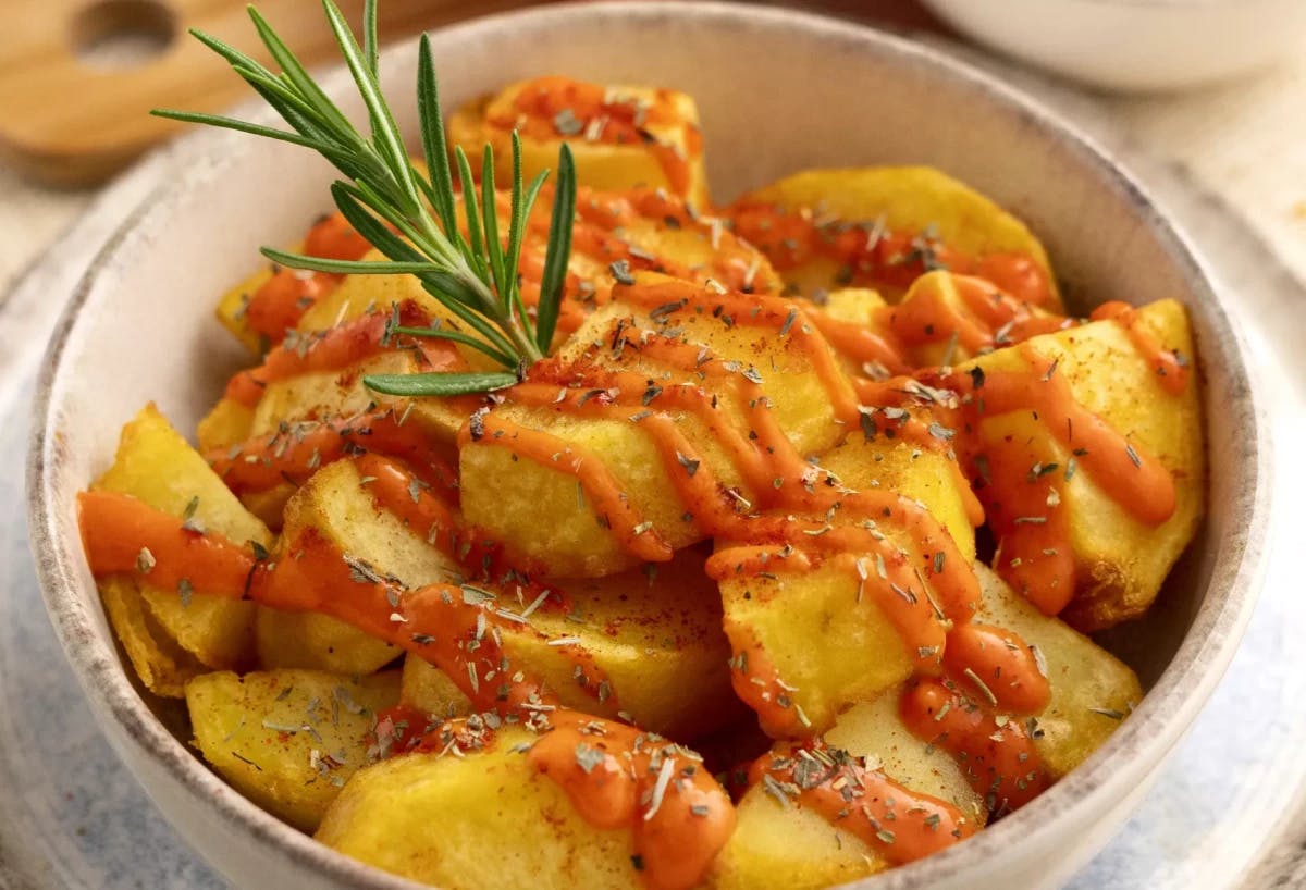 Potatoes with savory sauce, known as patatas bravas, served as a delicious and flavorful dish.