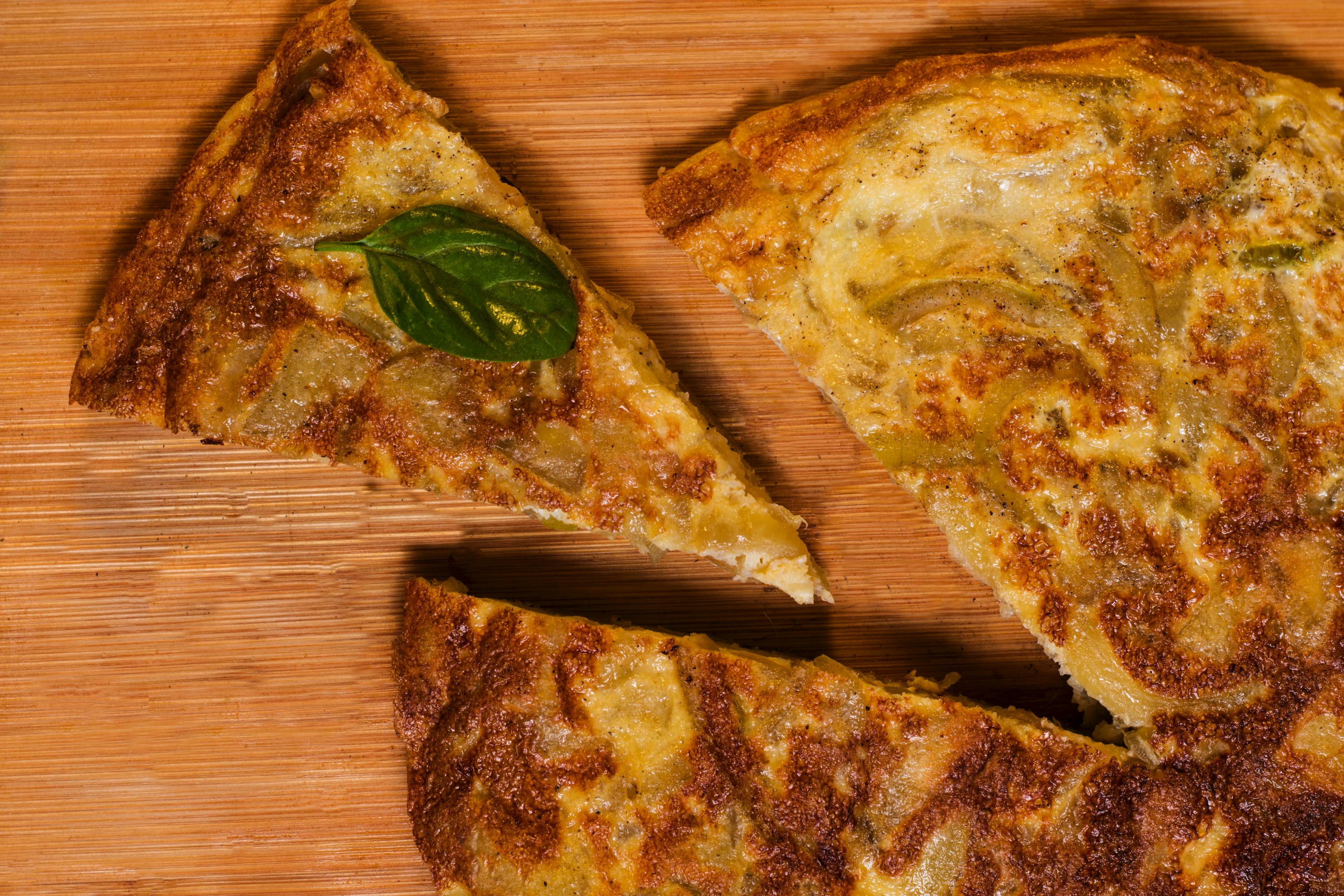 A delicious tortilla española served on a wooden table.