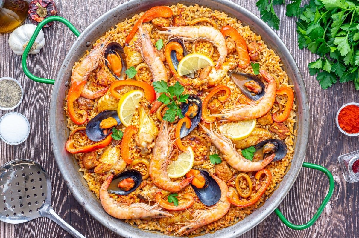 Paella mixta with a delightful blend of seafood and meats, creating a mouthwatering Spanish dish.