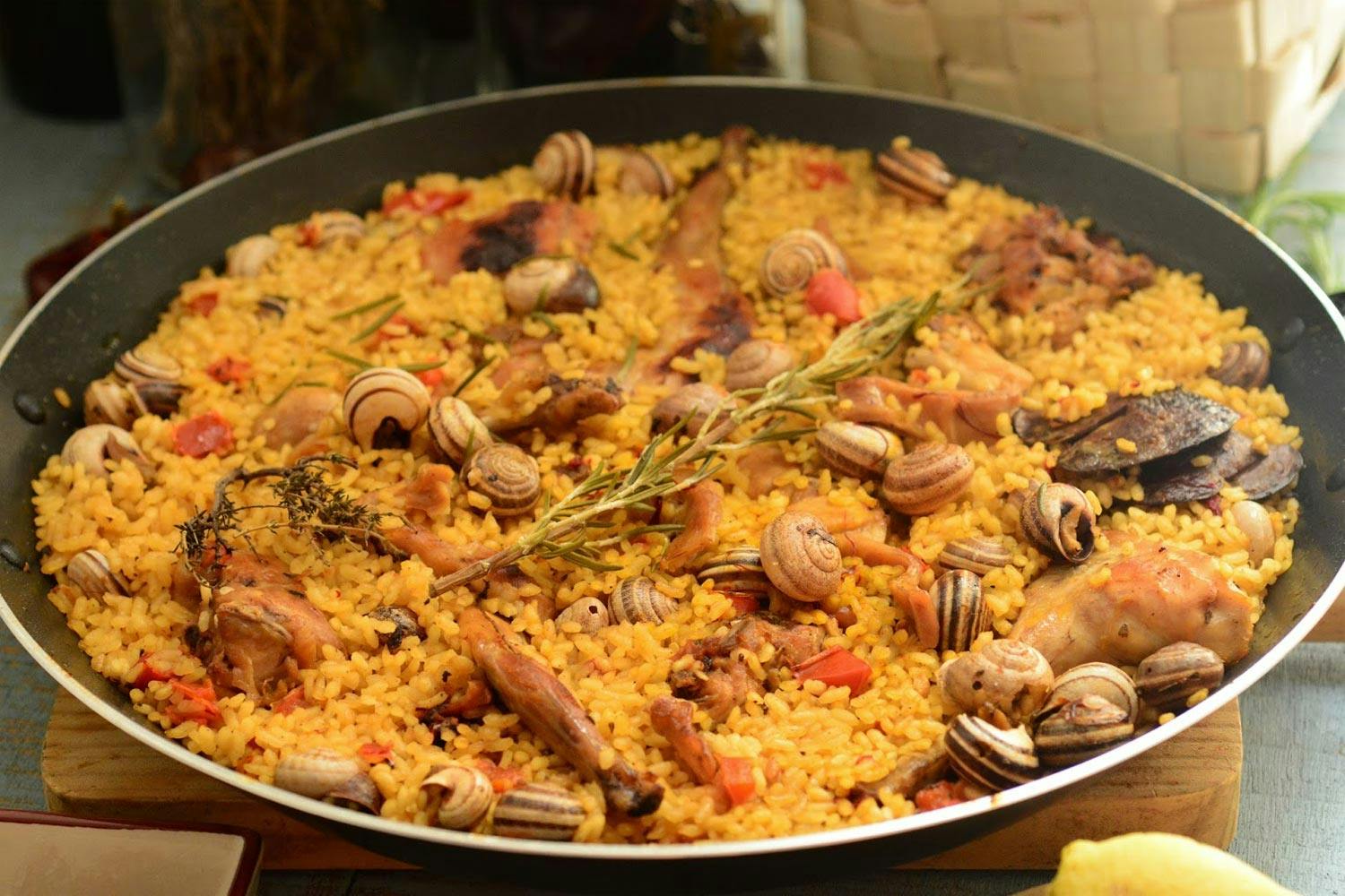 Paella with rabbit and snails, known as "Paella de conejo y caracoles".