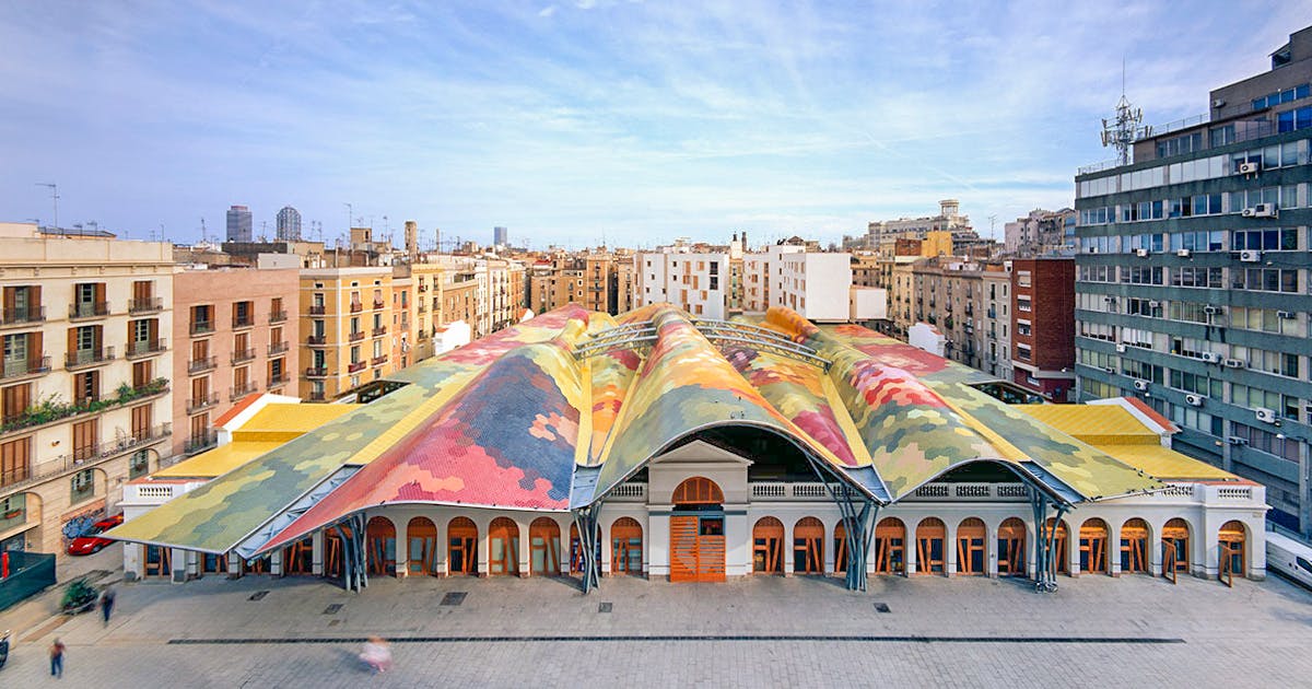 The Mercat de Santa Caterina in Barcelona, a large building with vibrant tiled roofs.