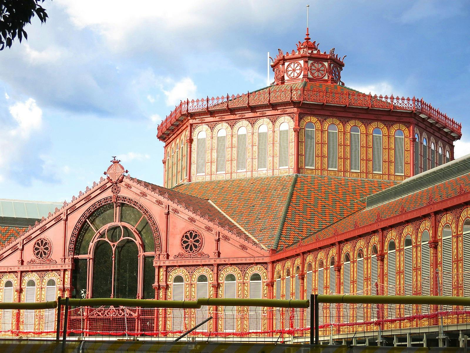 A majestic and colorful market building, known as Mercat de Sant Antoni.