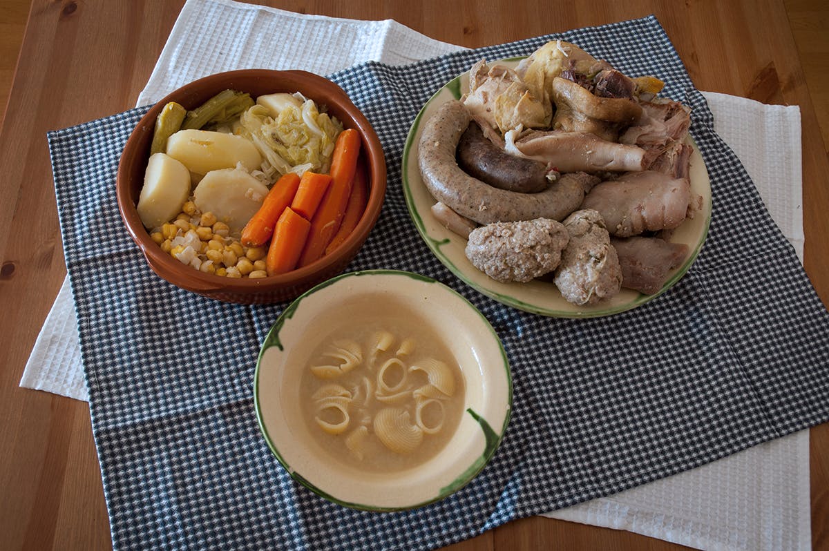 Traditional Catalan dish, Escudella i Carn d'Olla, served on a table.