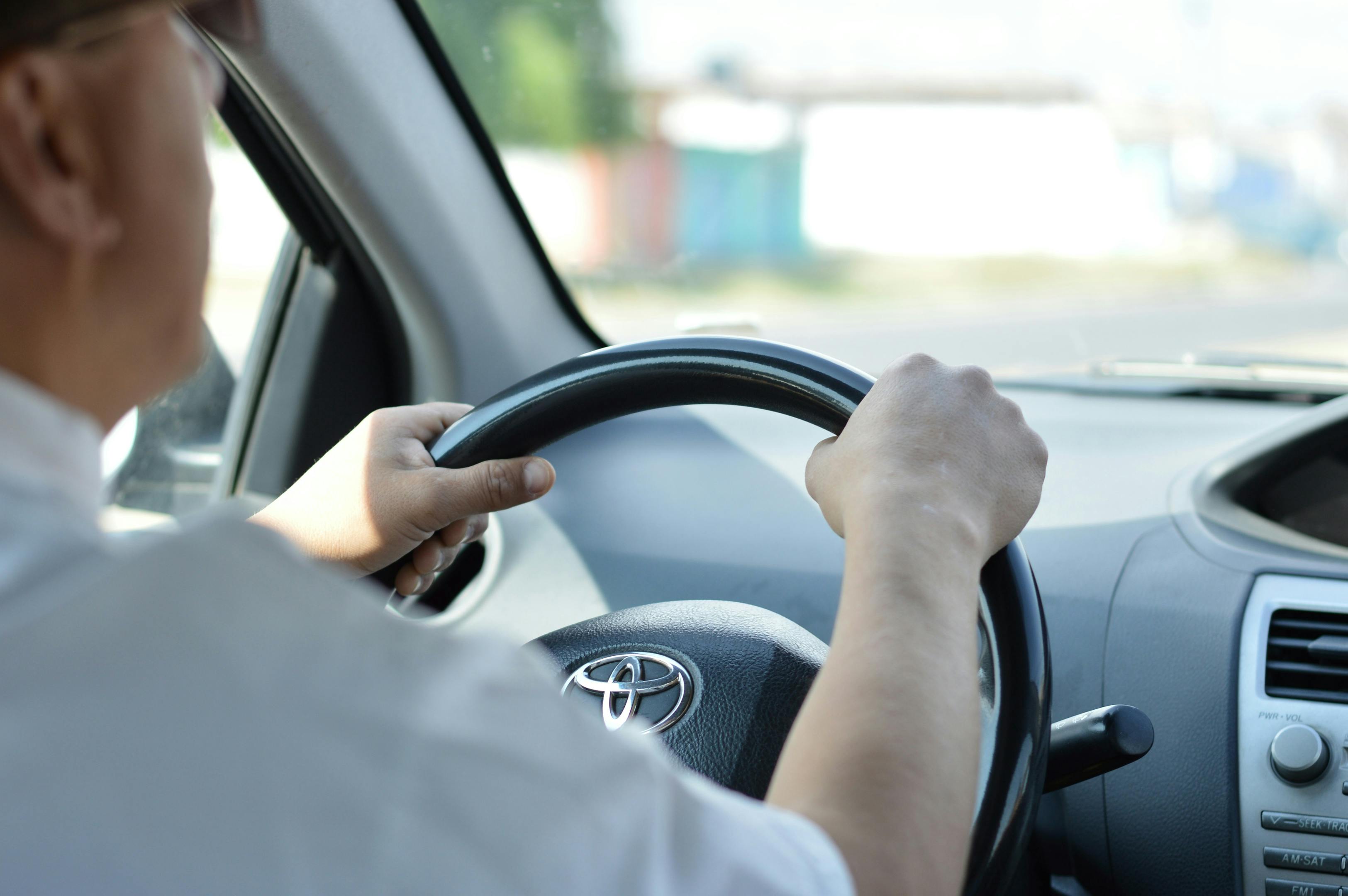 A man driving a car for a private transfer service.