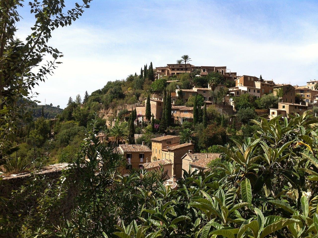 A picturesque village nestled on a hillside in Deia, Mallorca.