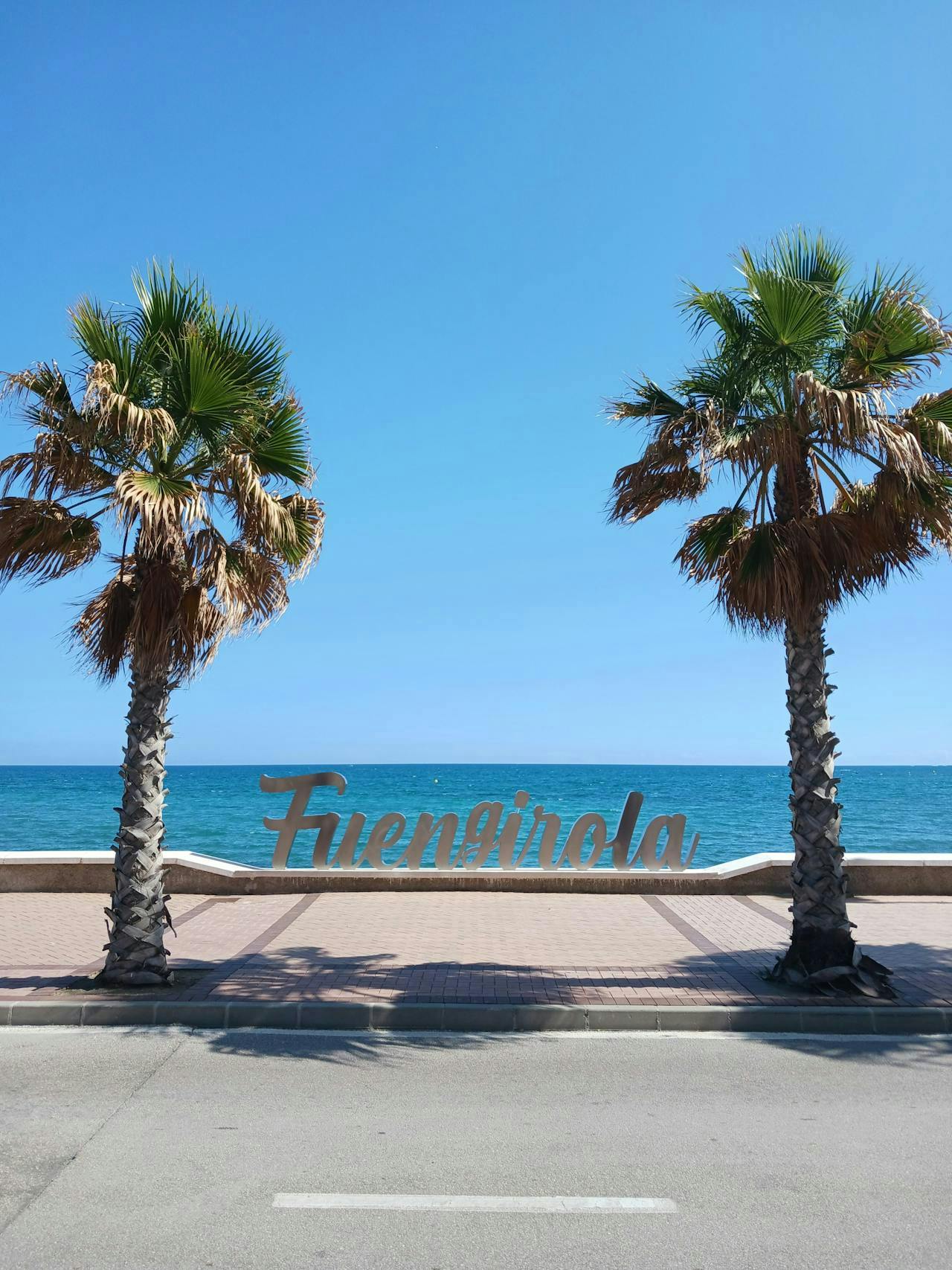 Scenic view of Francienella Beach in Fuengirola, Costa del Sol, showcasing golden sands and clear blue waters.