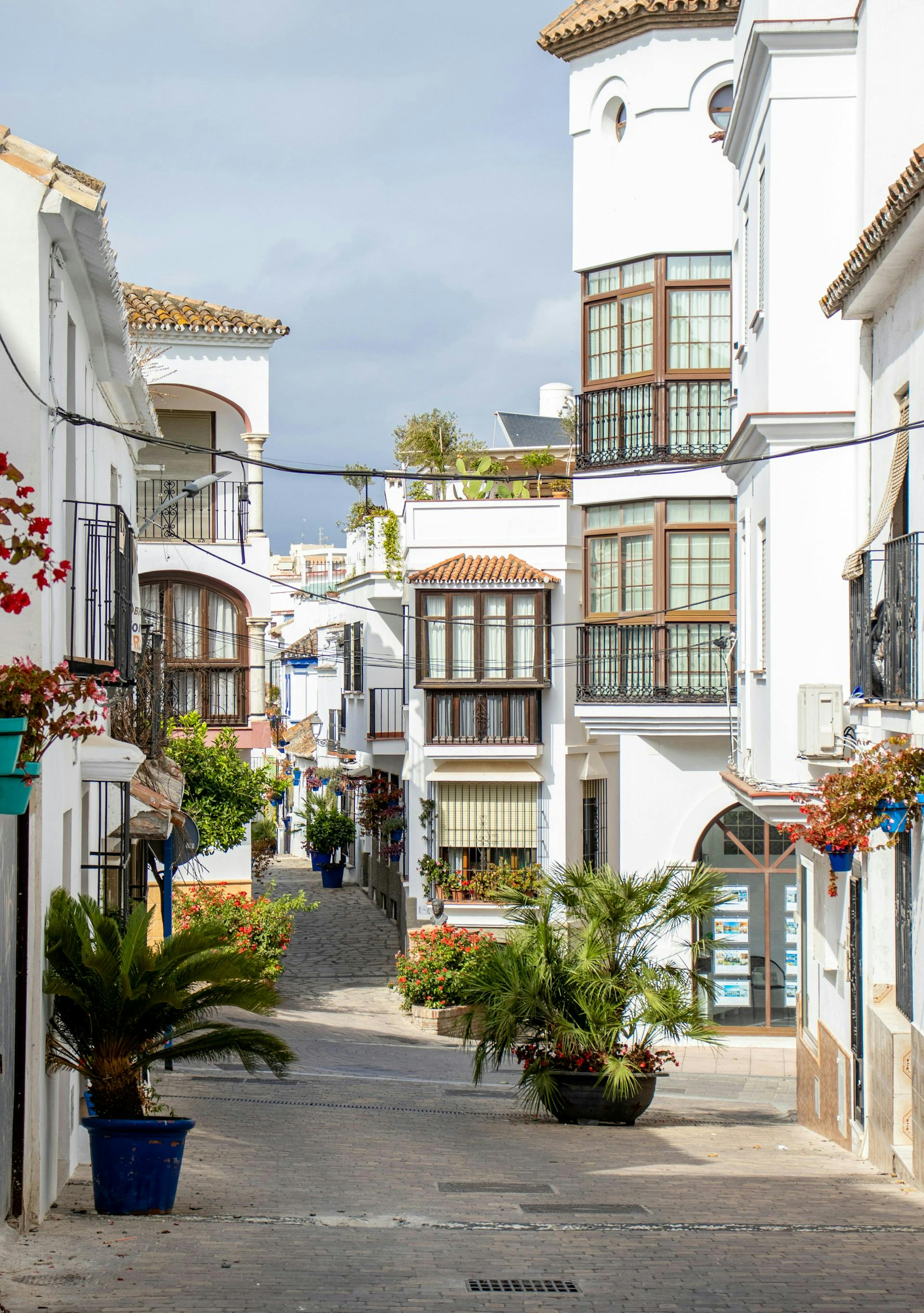 A white building with black windows located in Estepona, Malaga, showcasing a modern architectural design.