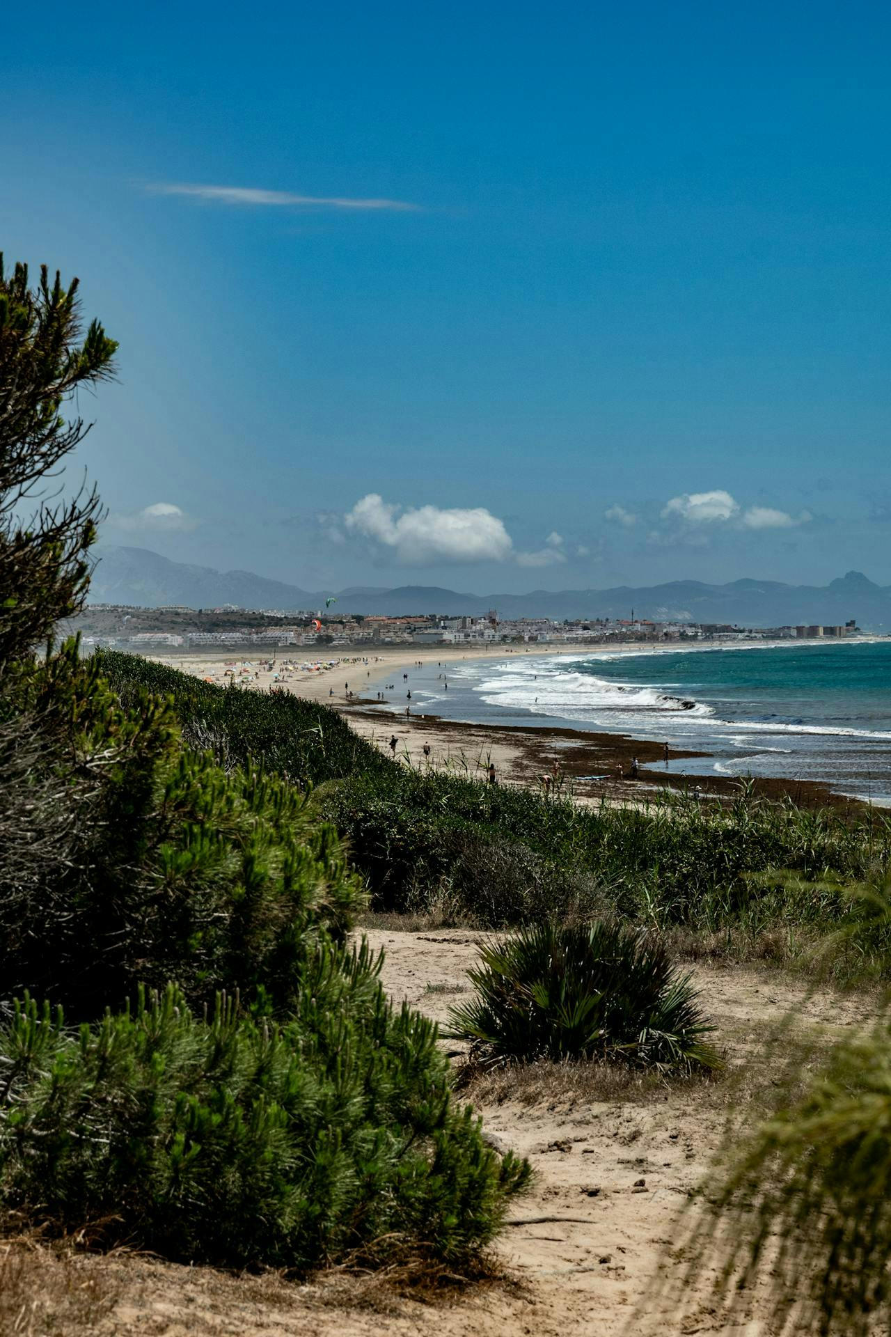 Une plage sereine à Tarifa sous un ciel bleu clair, mettant en valeur la beauté de la nature et la tranquillité.