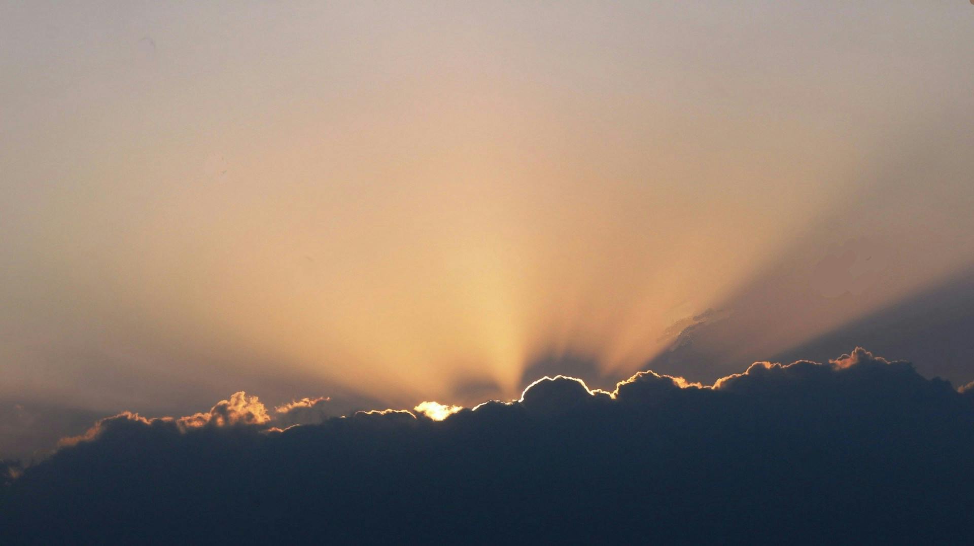 Sunrise: Majestic sun rays piercing through fluffy clouds, creating a breathtaking celestial spectacle.