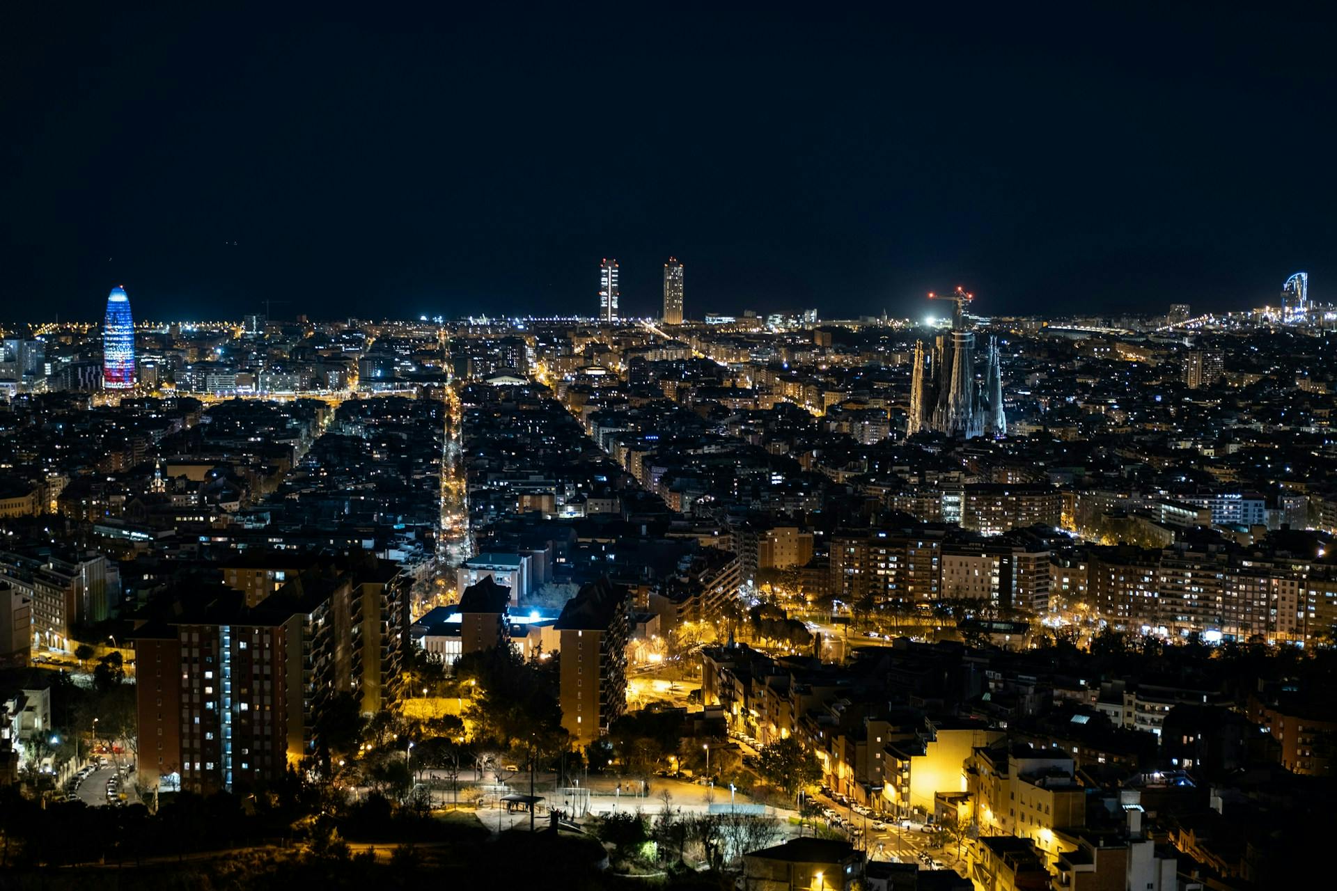 A stunning Barcelona cityscape illuminated at night, showcasing the vibrant lights and architecture of the city.