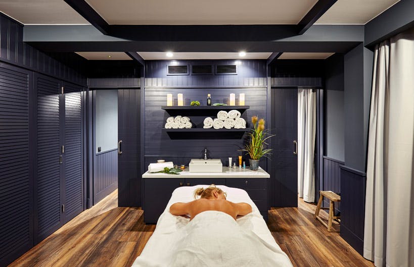 A woman receiving a massage in a spa room.