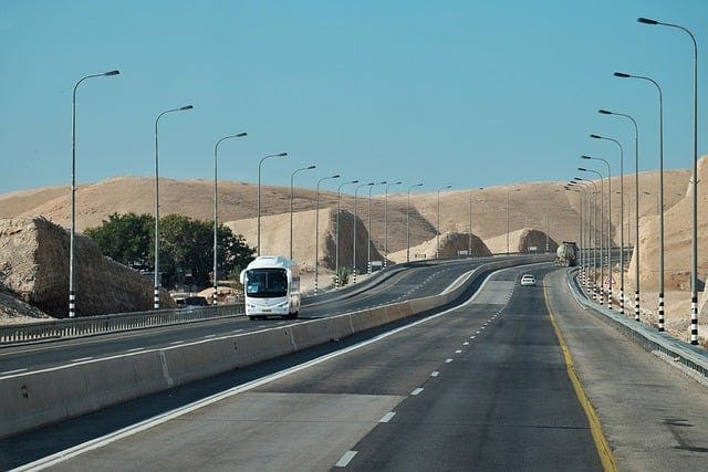 A bus on a route, cruising on a highway. 