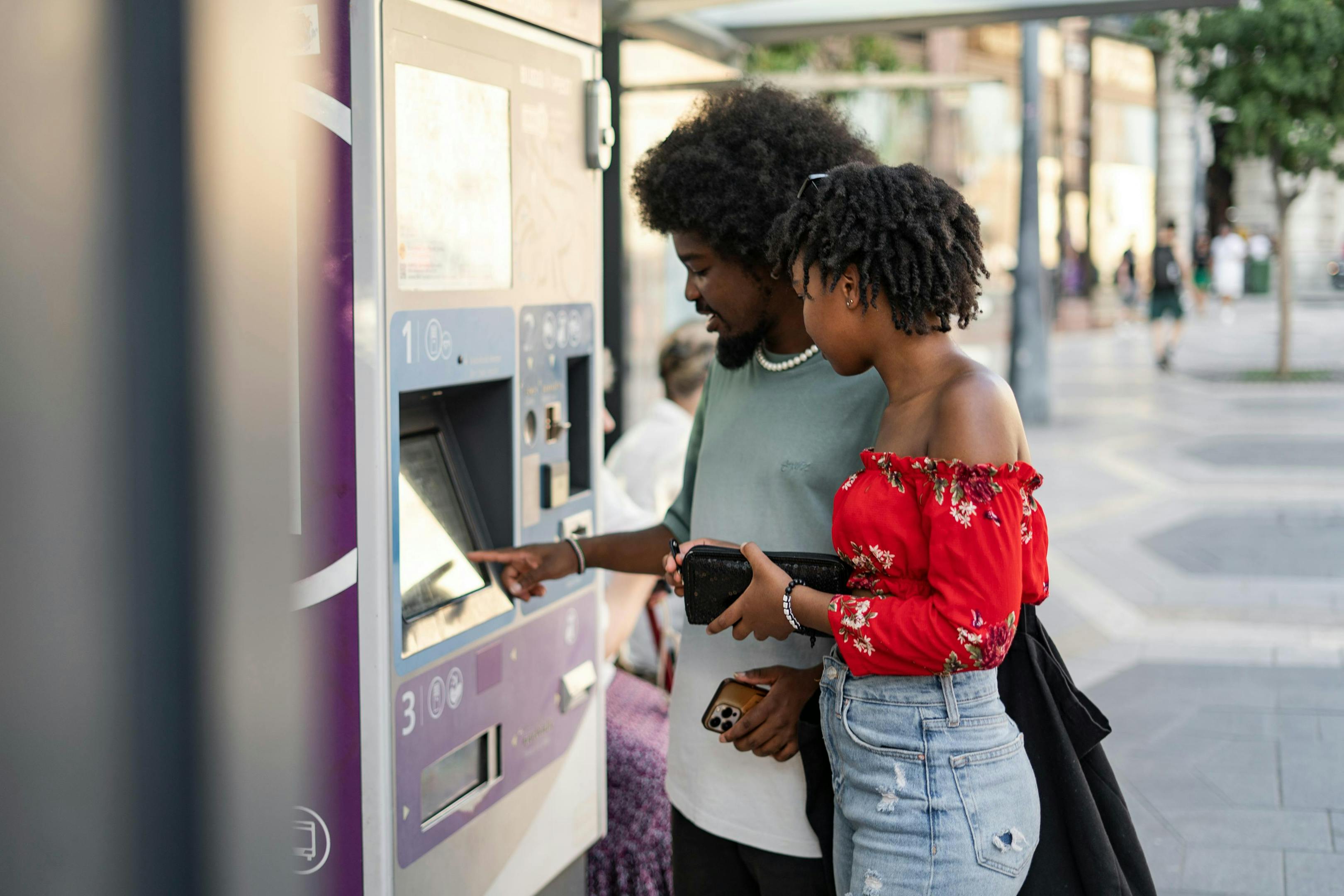 A couple purchasing tickets for the bus.