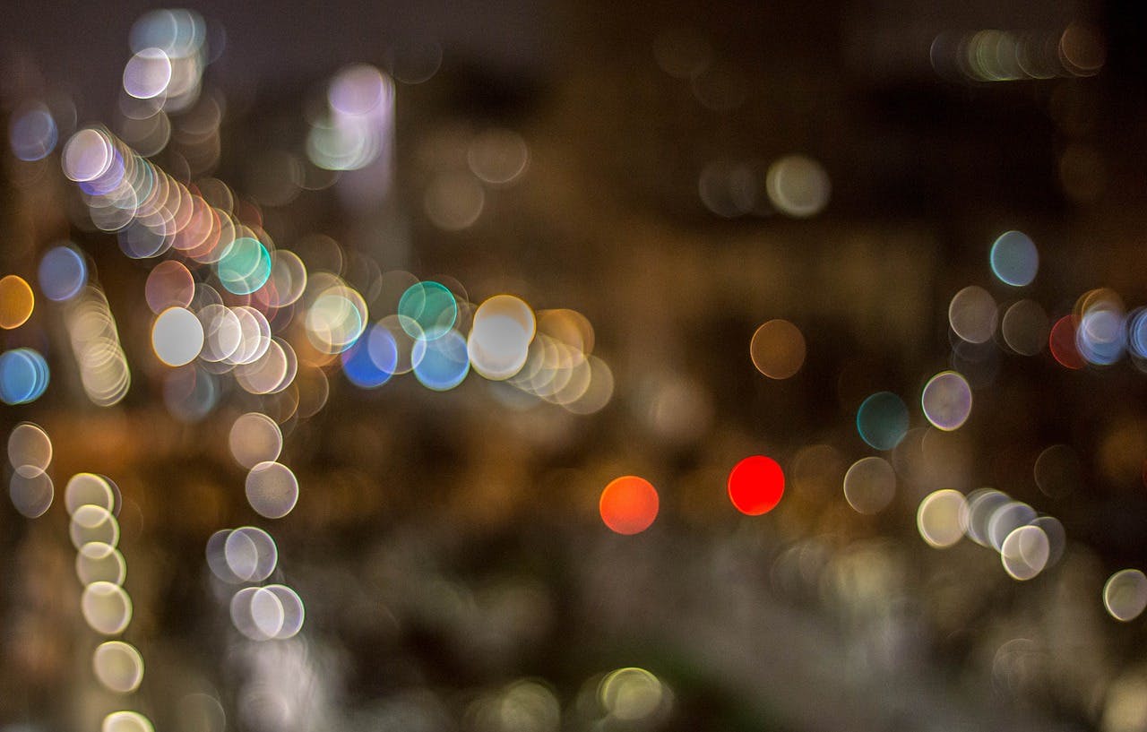 Blurred lights illuminate a city at night, creating a mesmerizing display of vibrant colors and urban energy.