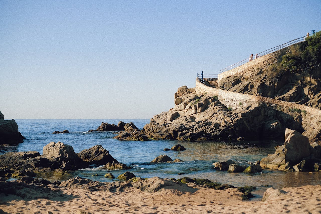  Scenic path leading to ocean and rocks in Lloret de Mar.