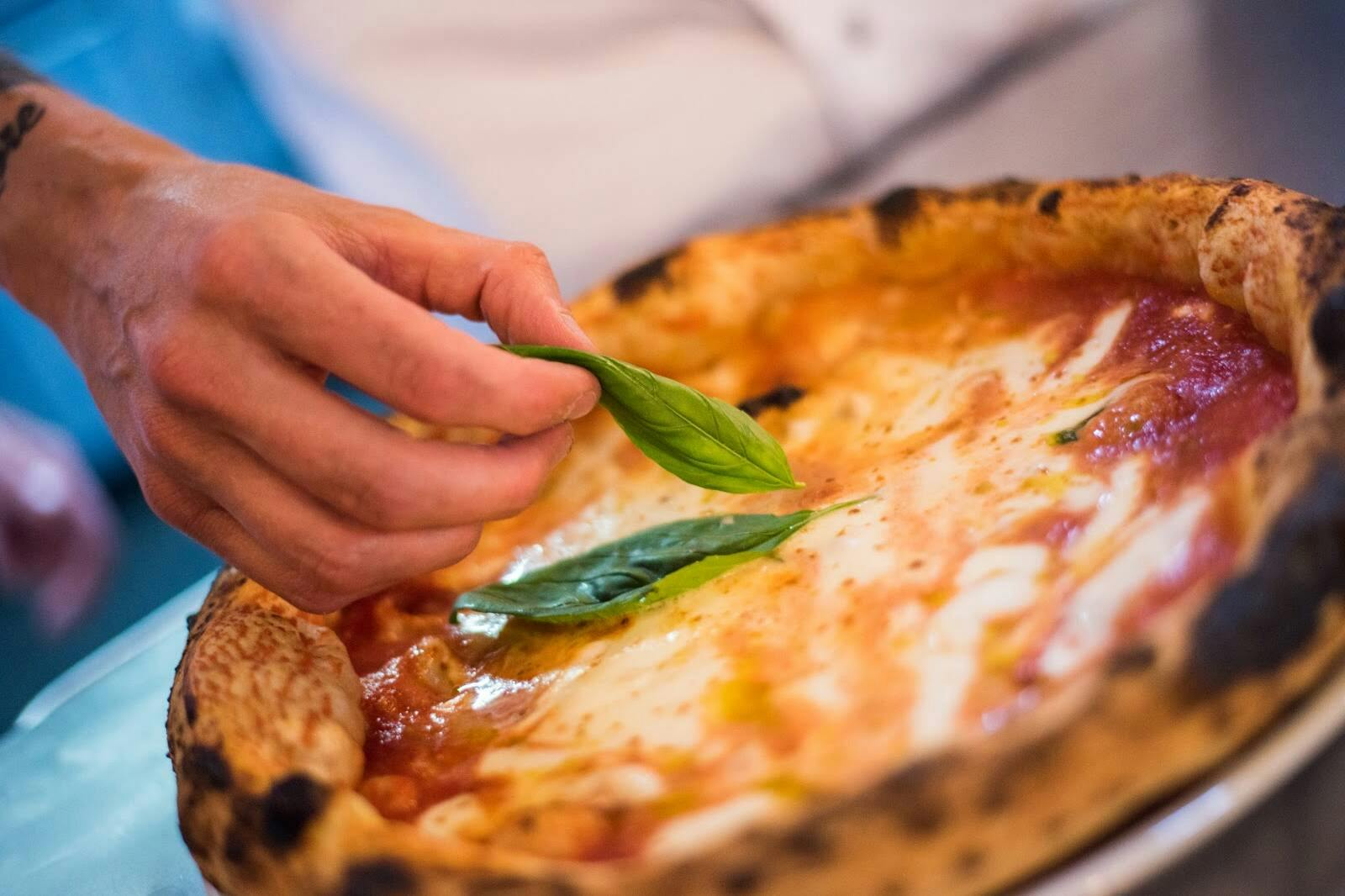 A delicious pizza on a plate at a restaurant in Lloret de Mar.