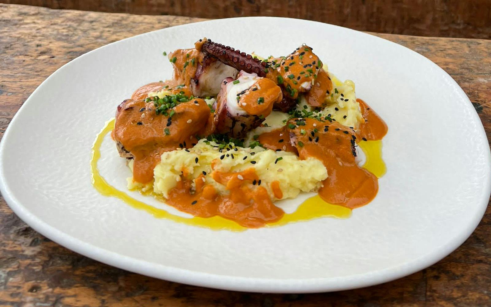 Plate of food on mashed potatoes at a restaurant in Lloret de Mar.