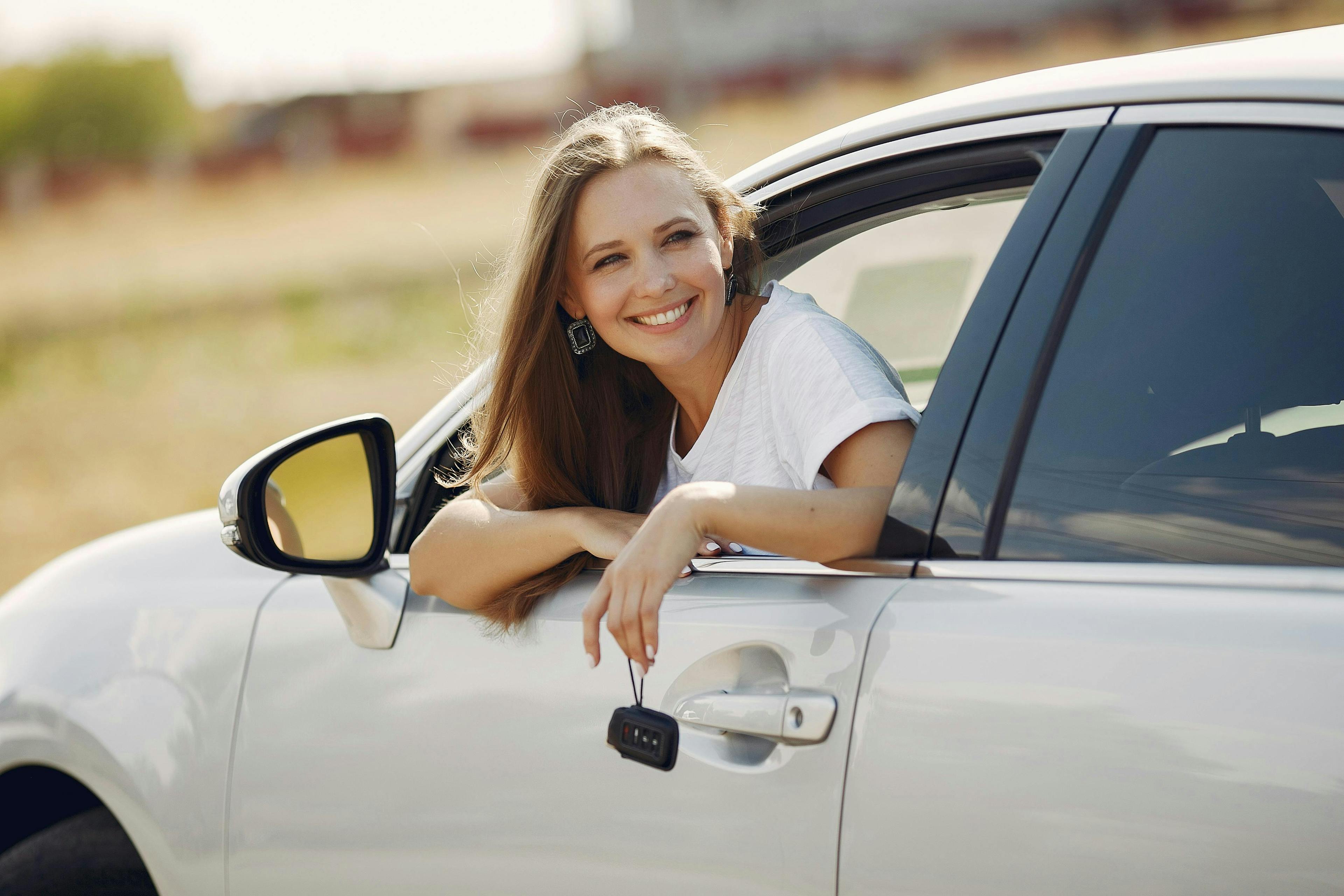 A woman in a car, representing the cheapest rental cars. 