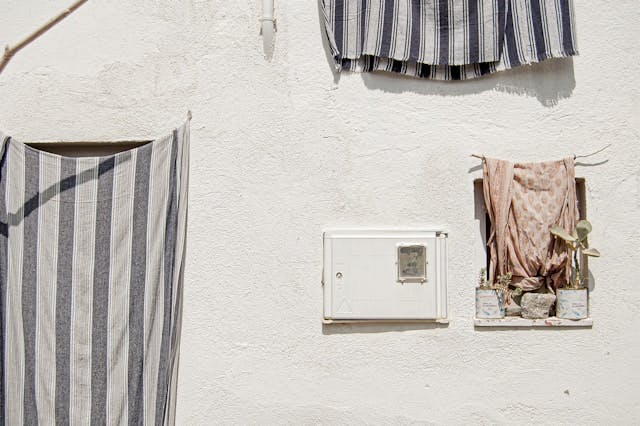 White building with window and door in Cadaqués, typical of the charming white houses in the area.