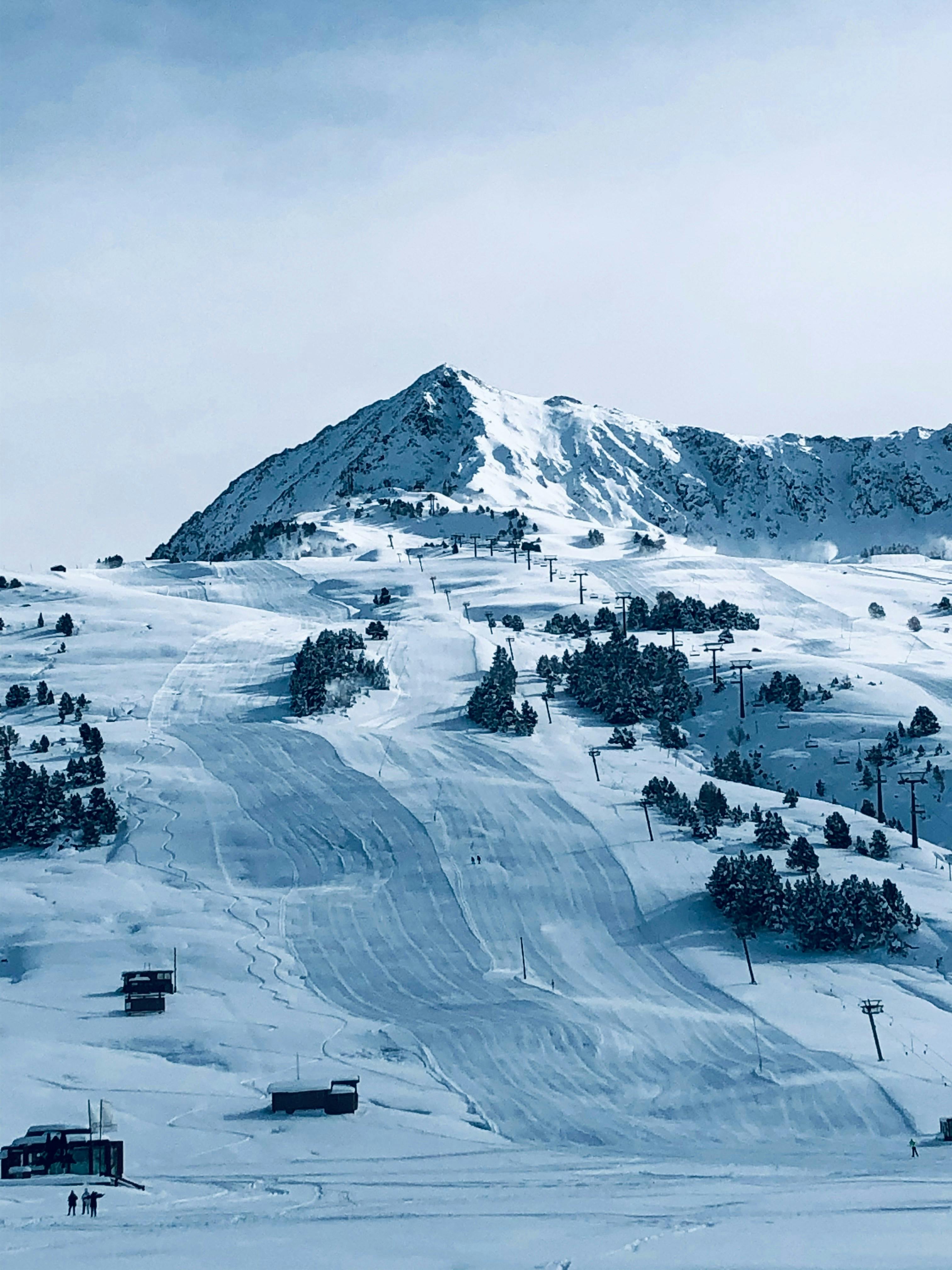 Ski slope on snowy mountain at resort.