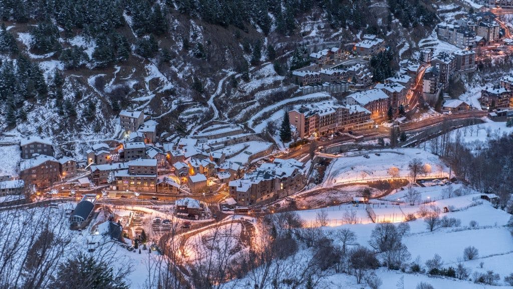 An aerial view of a picturesque mountain village nestled amidst the breathtaking beauty of nature.