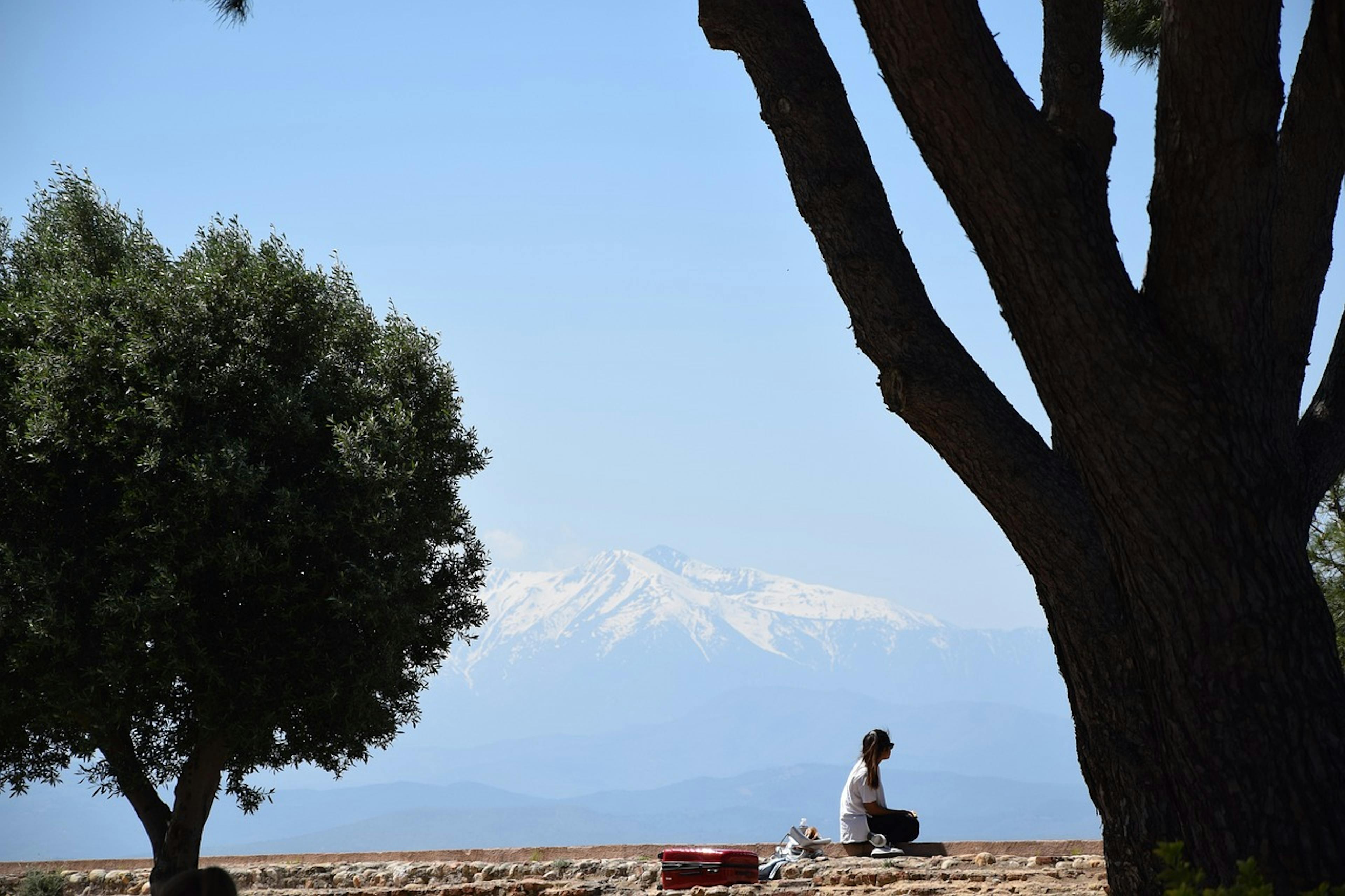  A person sitting on a bench in Perpignan.