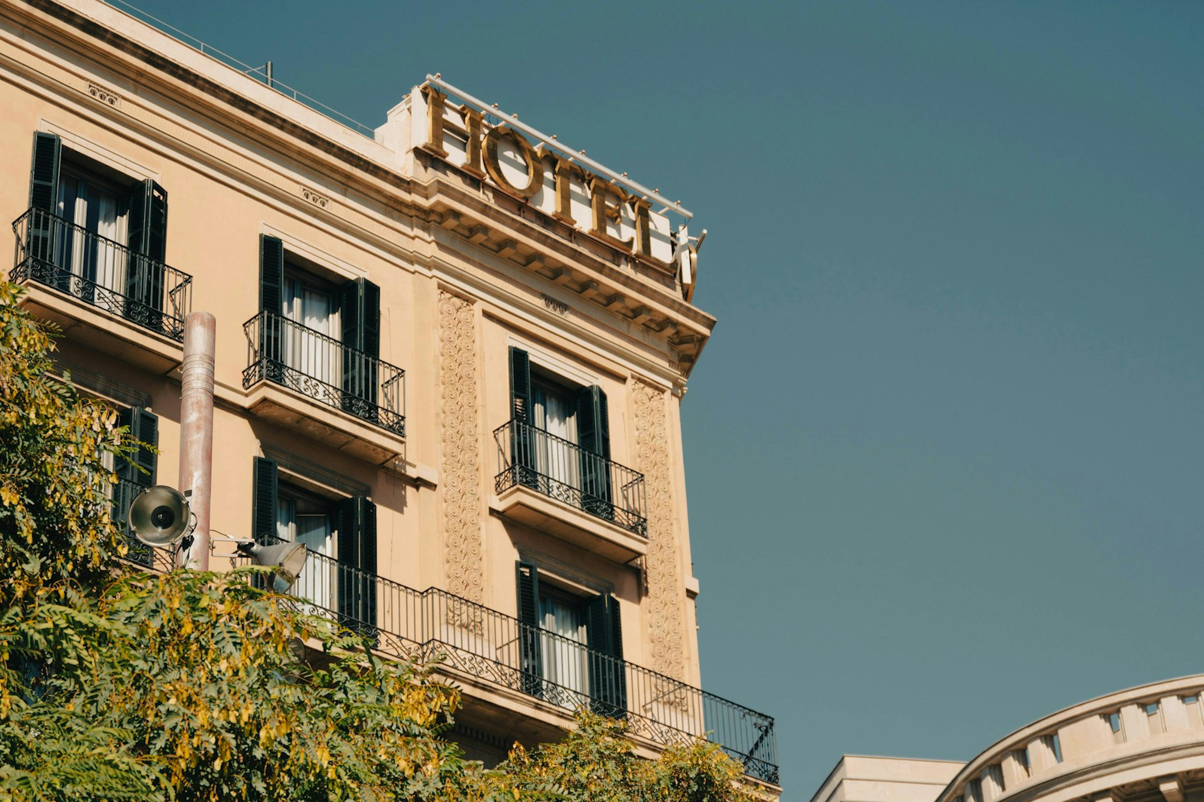 A hotel building with a sign.