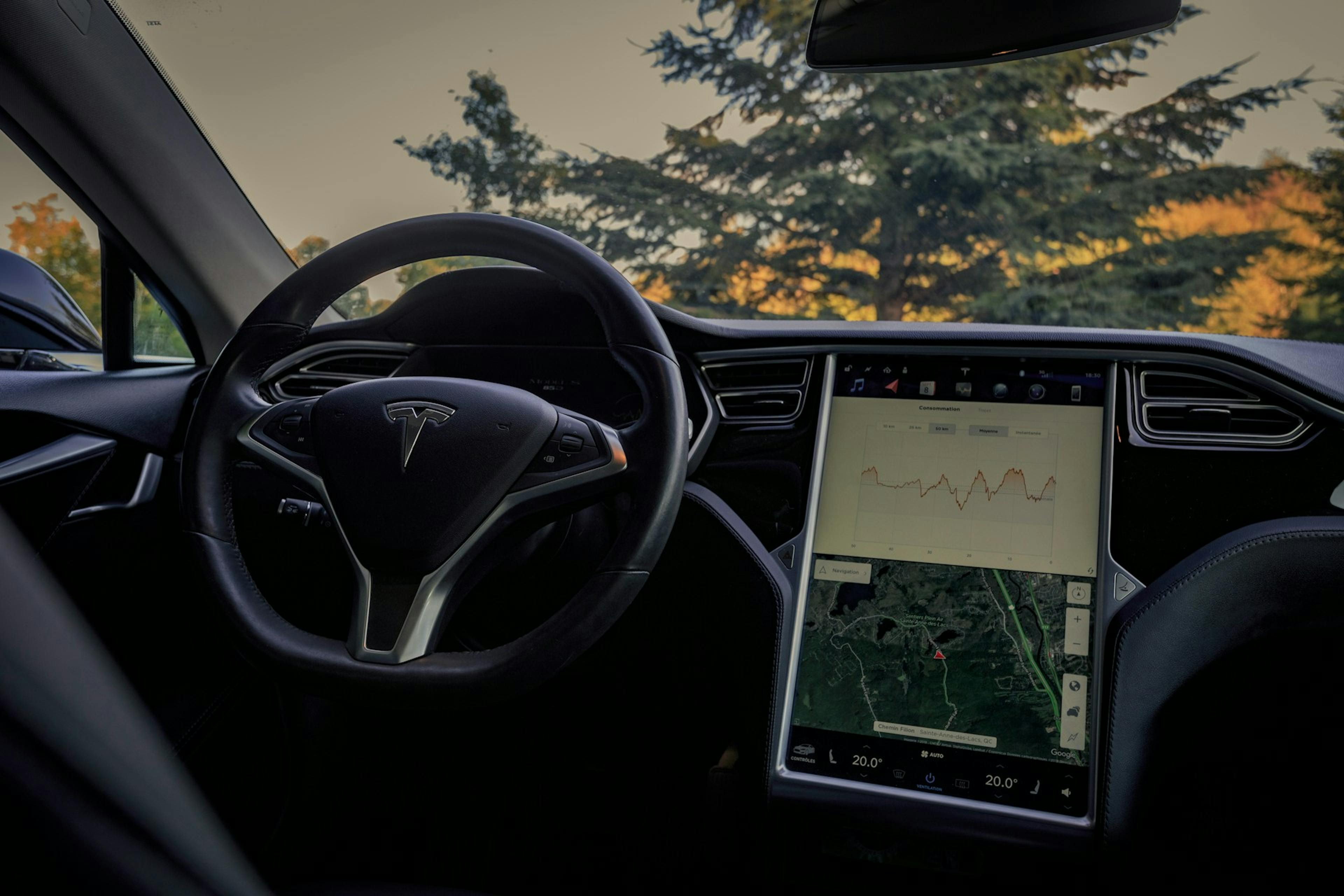 Image of a Tesla car's steering wheel, showcasing its sleek design and advanced technology features.