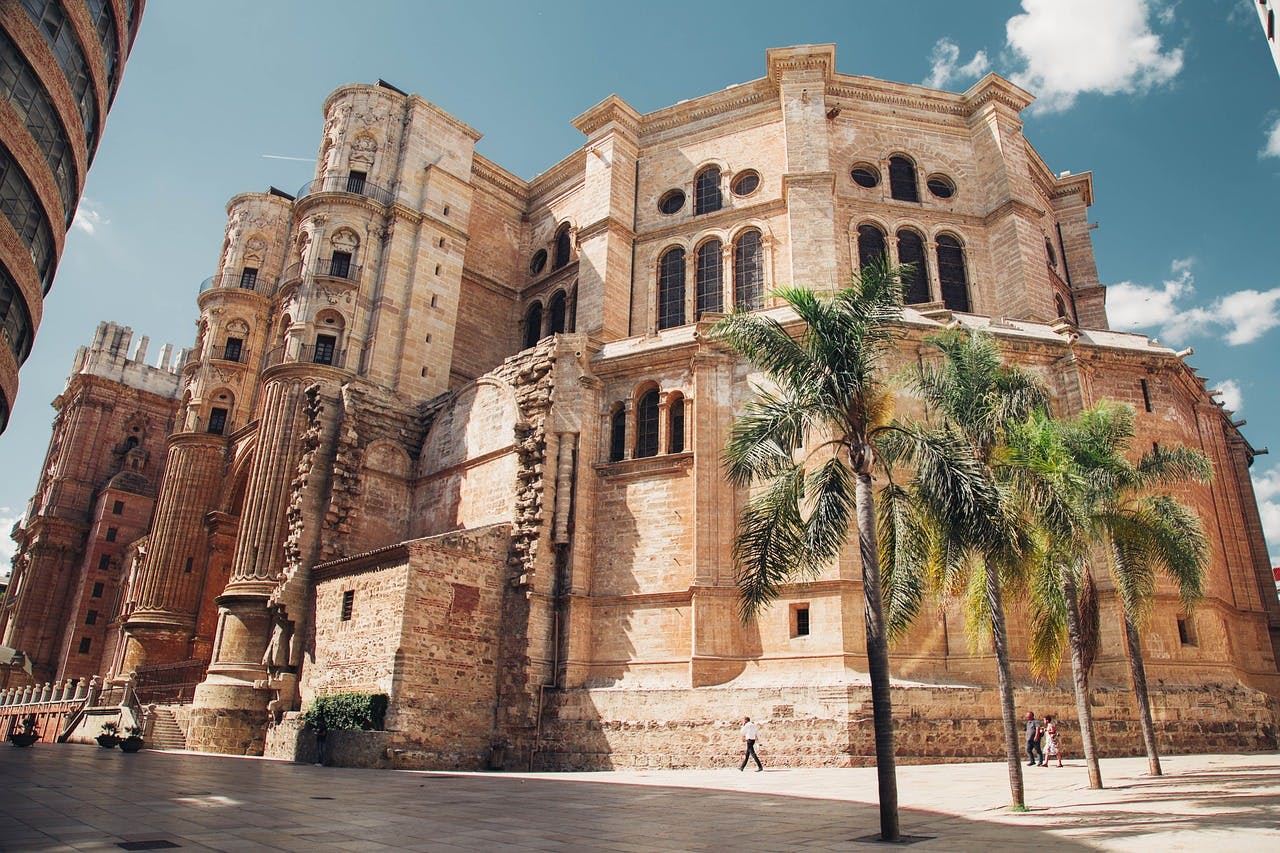 A grand cathedral with towering spires stands prominently in the heart of Malaga city, showcasing its architectural beauty.