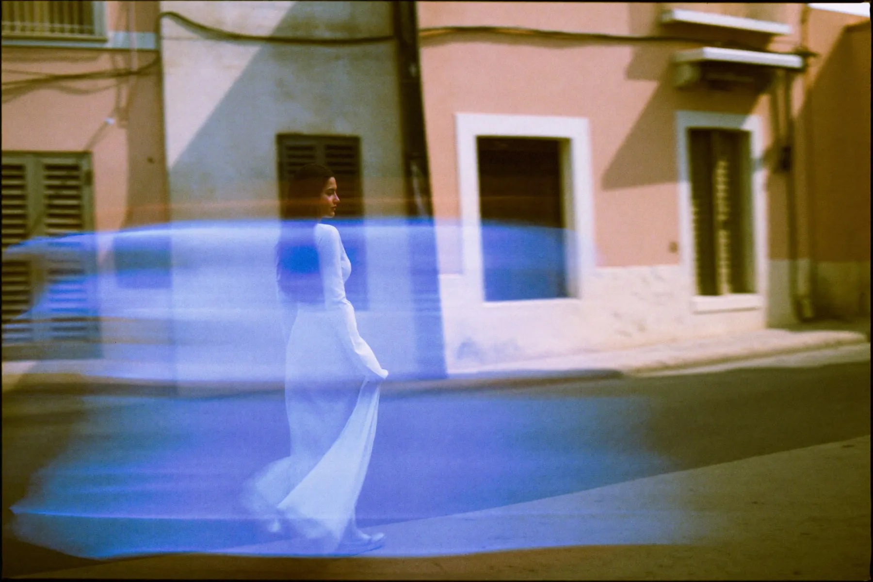 A hand flicking through the pages of a book on a Cairo balcony, the pages blurred by motion