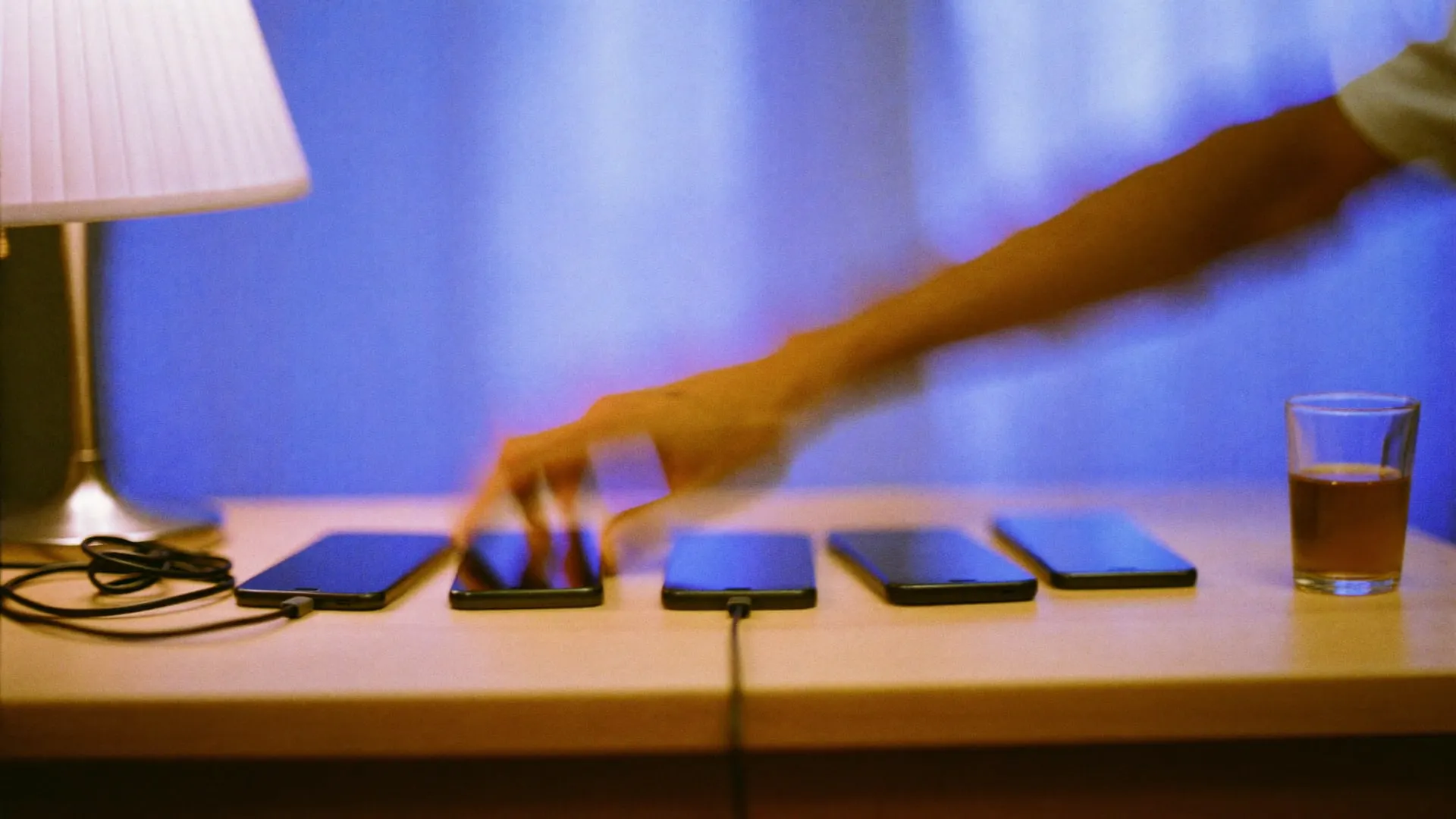 An engineer typing at a desk at night, lit by a monitor out of frame