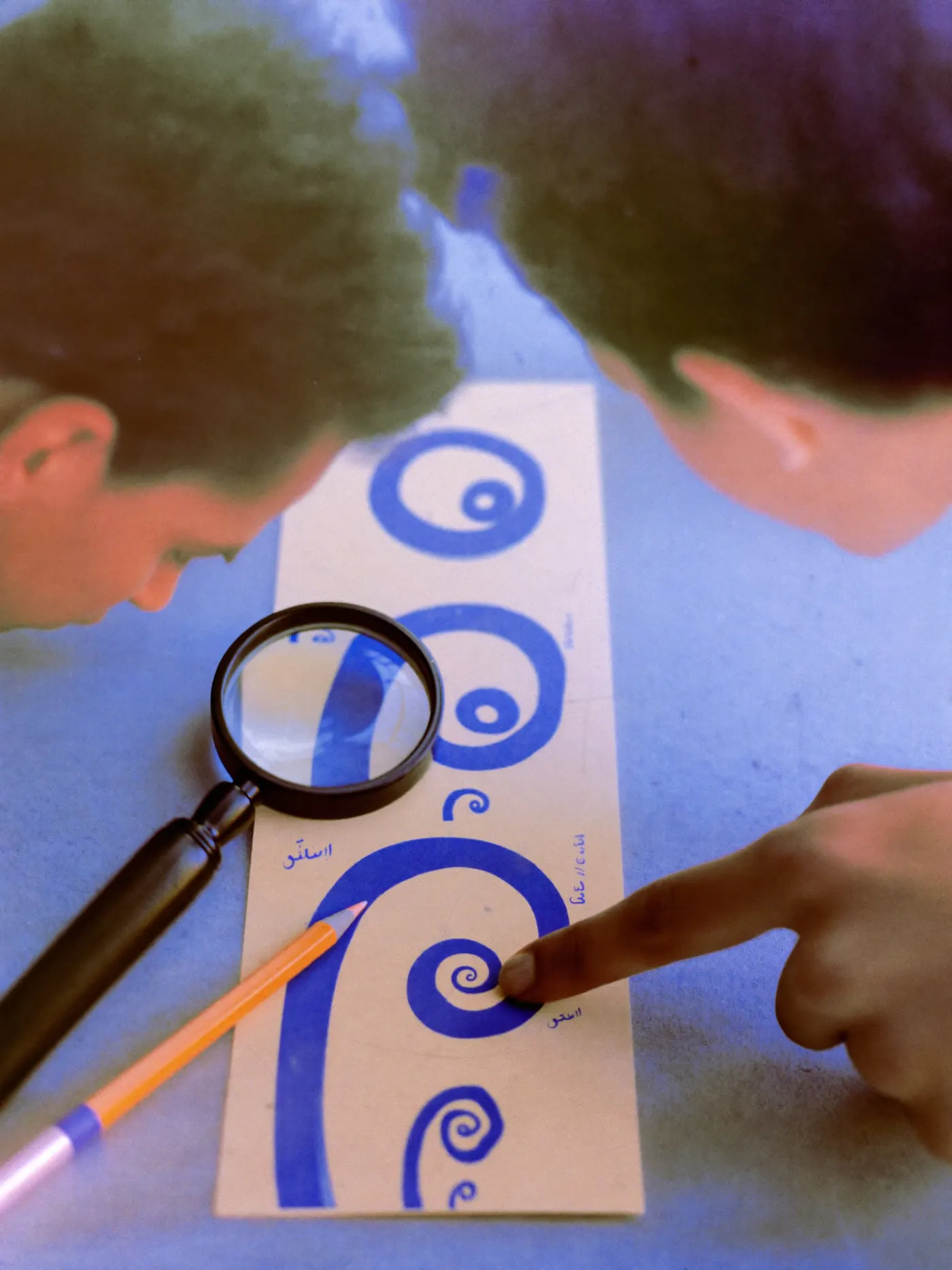 One symbol printed at five sizes from large to tiny, a loupe over the smallest