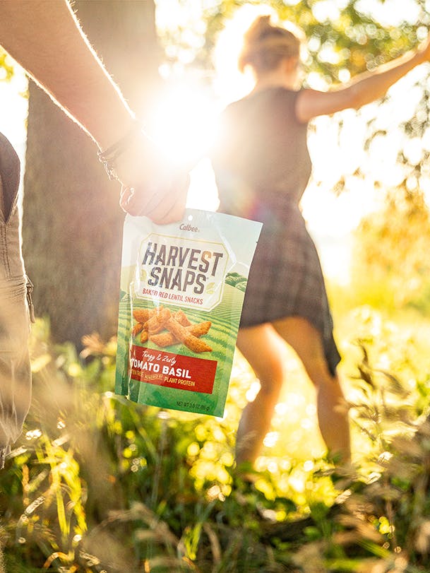 Two people hiking with harvest snaps