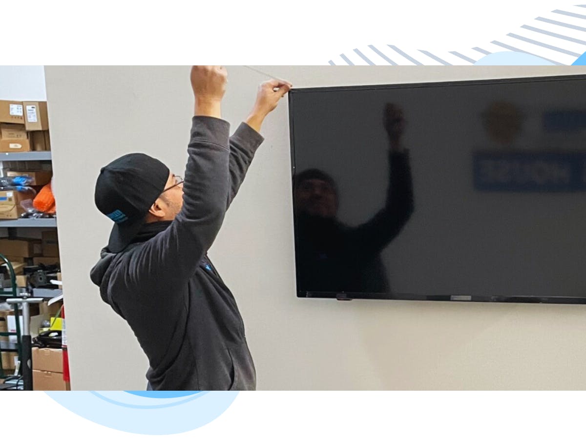 a tech hanging and installing a TV