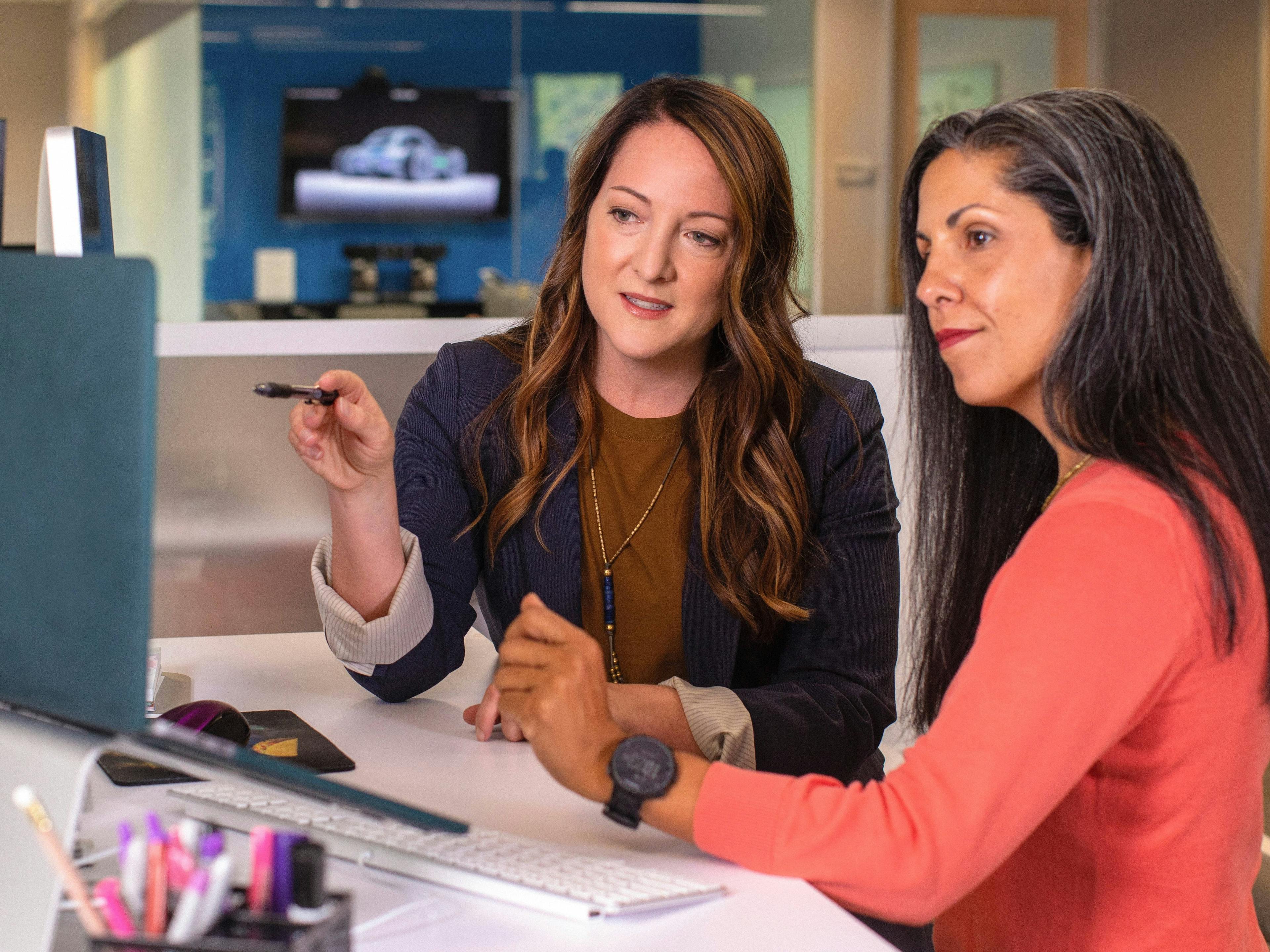 Two business women at work in a meeting at a computer