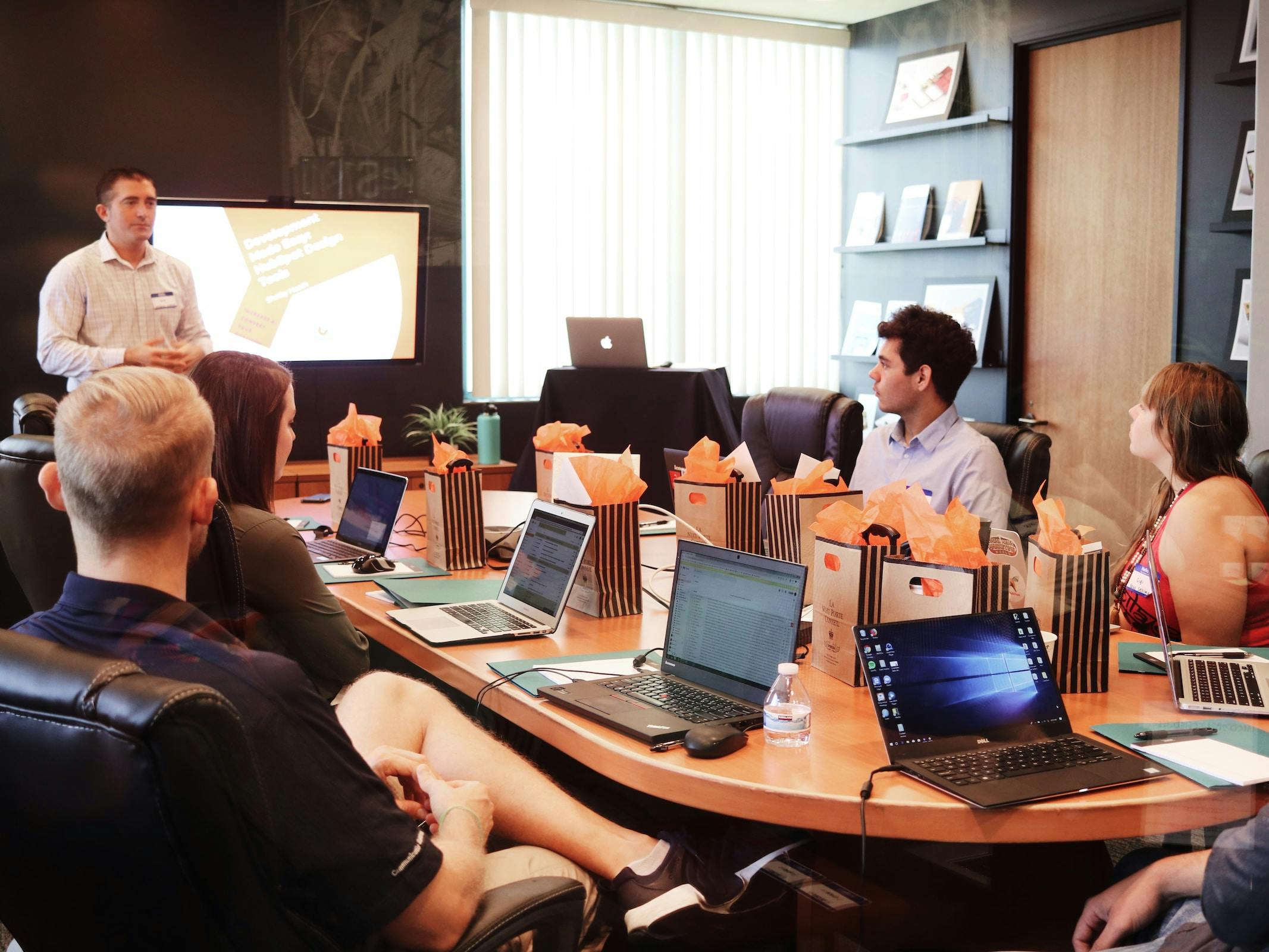 a team meeting with computers and lunches