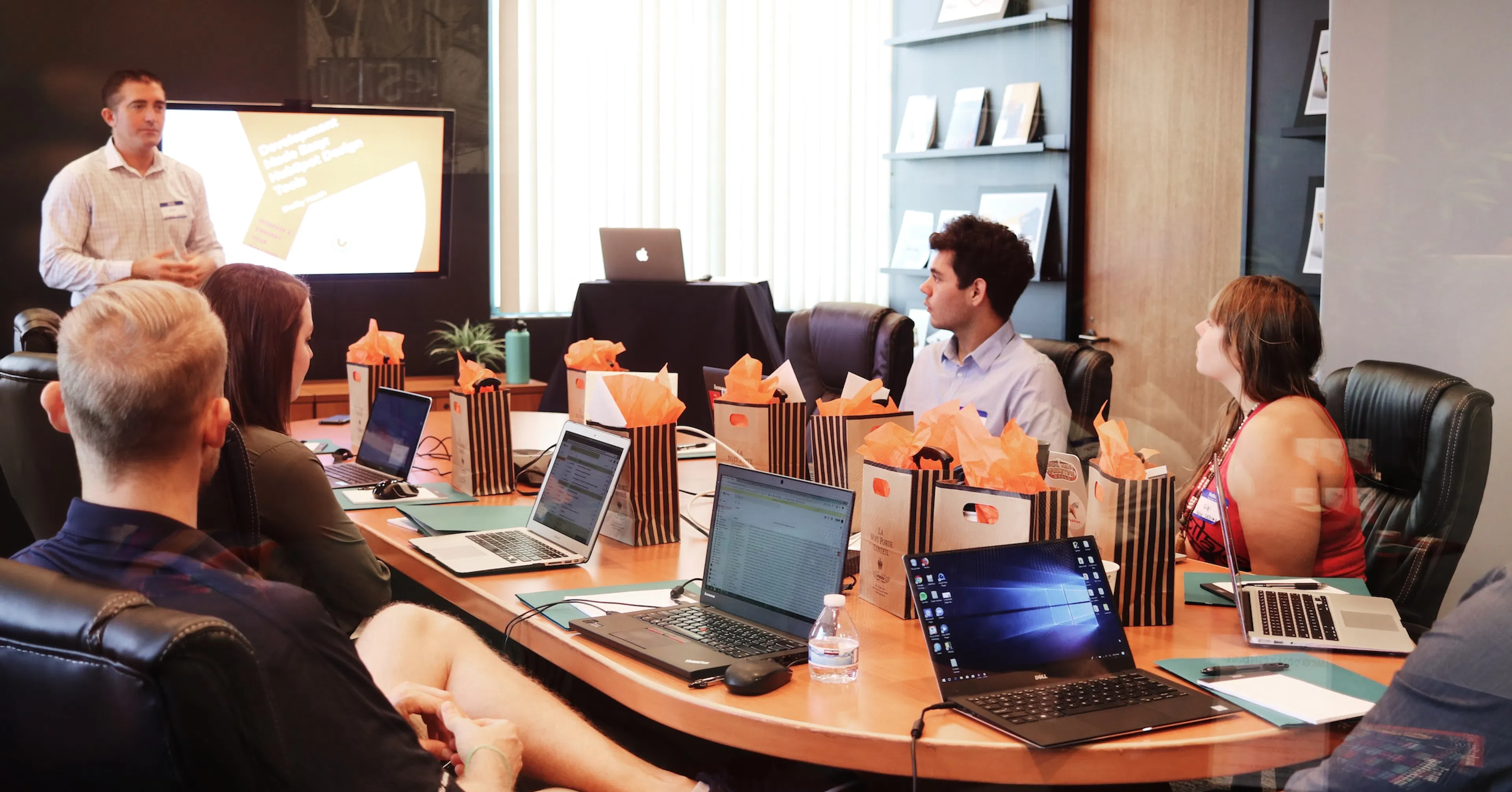 a team meeting with computers and lunches