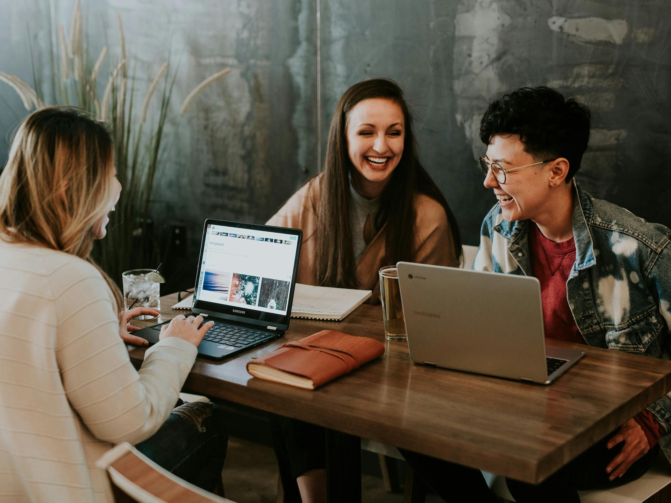 three young people working at computers