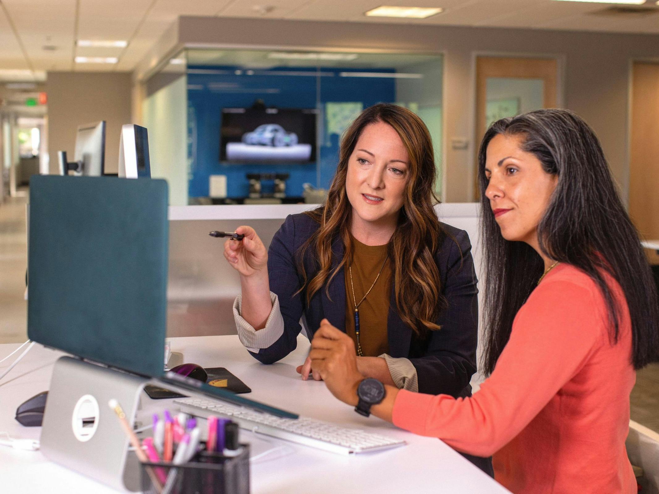 two woman in a business meeting reviewing a computer screen