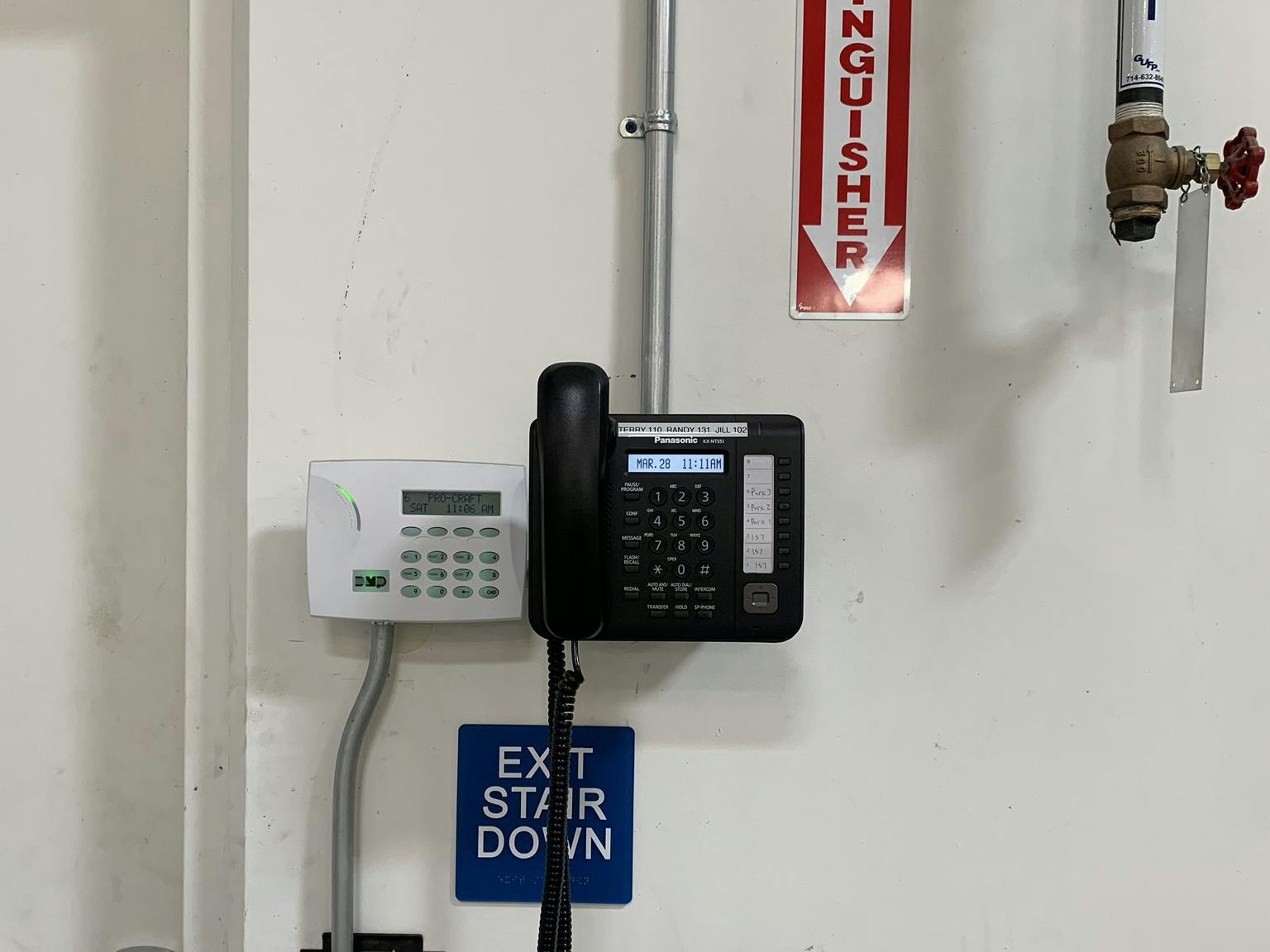 a wall-mounted VoIP phone in a warehouse