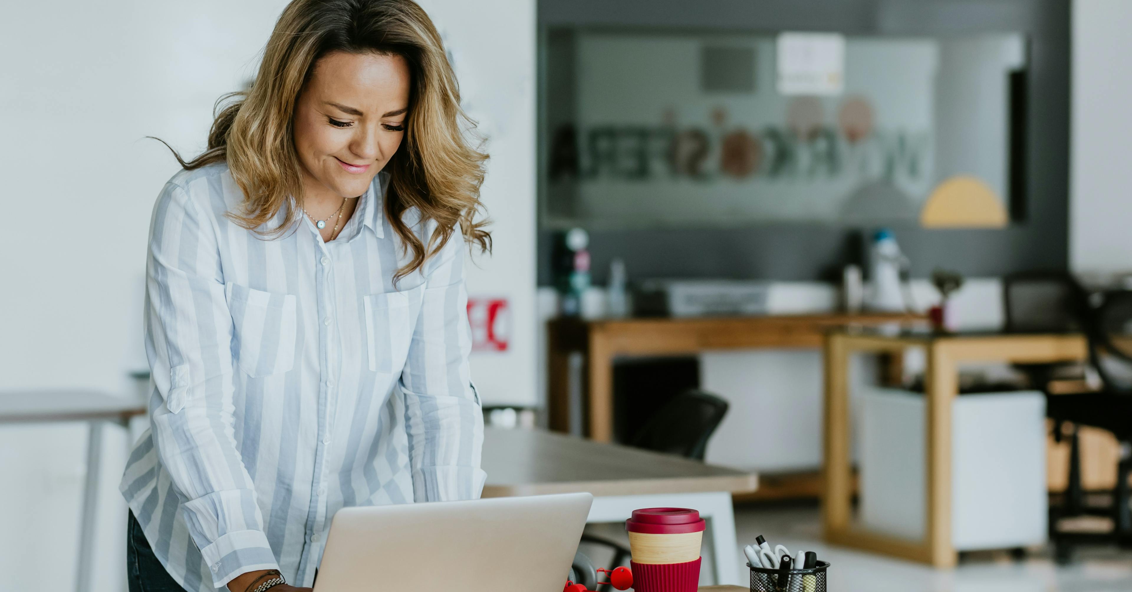 a lady standing and working in a home office