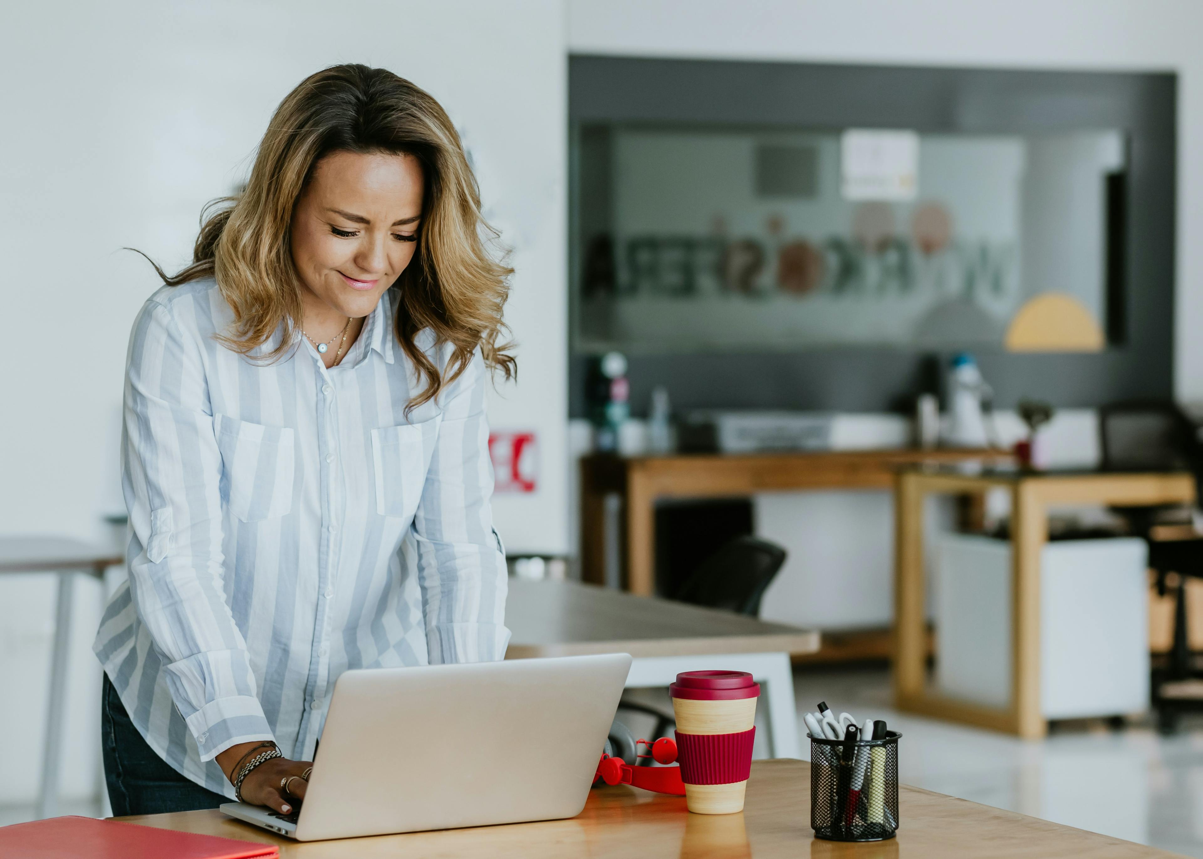 a lady standing and working in a home office