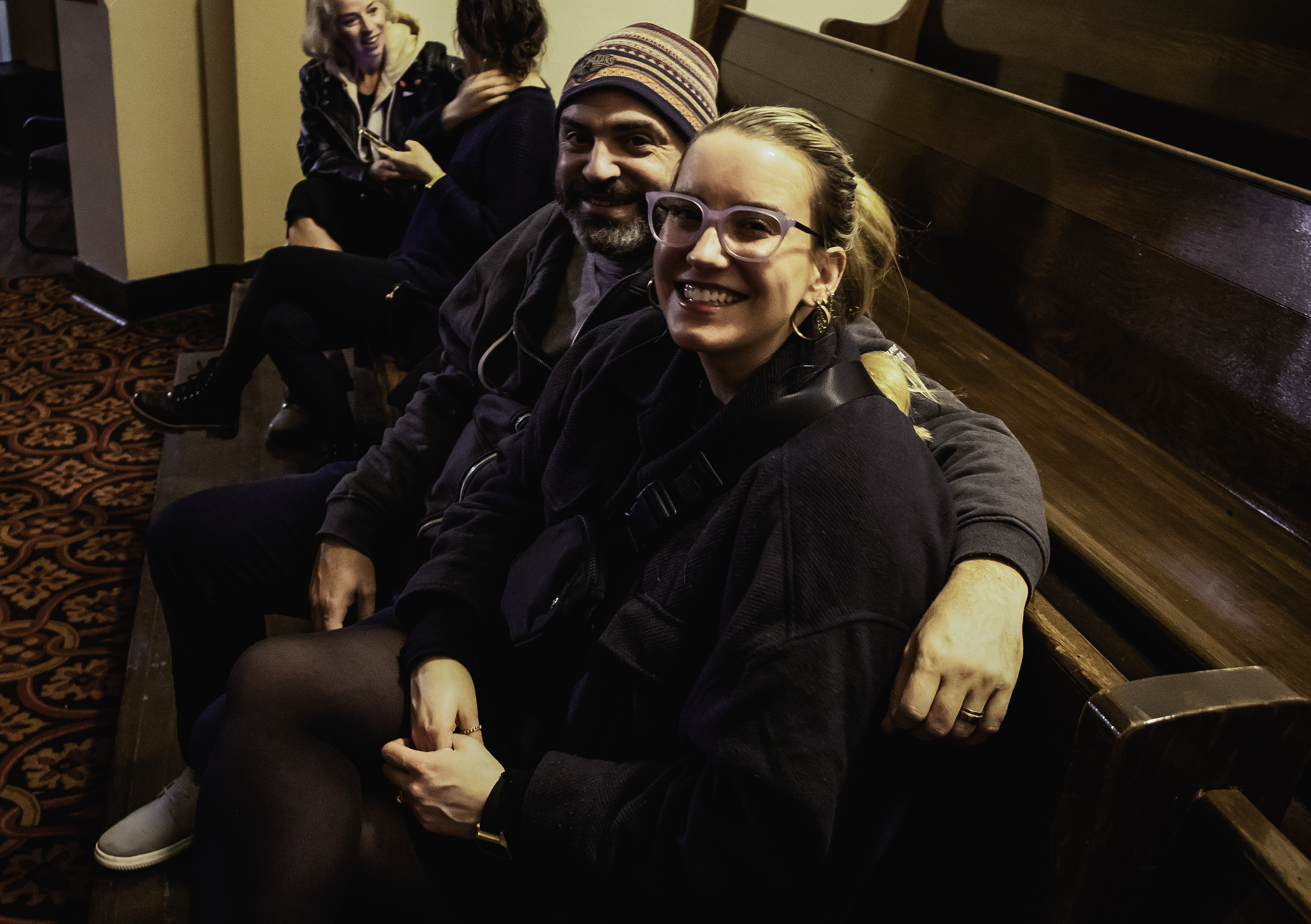 Audience members smile in the pews at Central United Church for Block Heater 2023. 