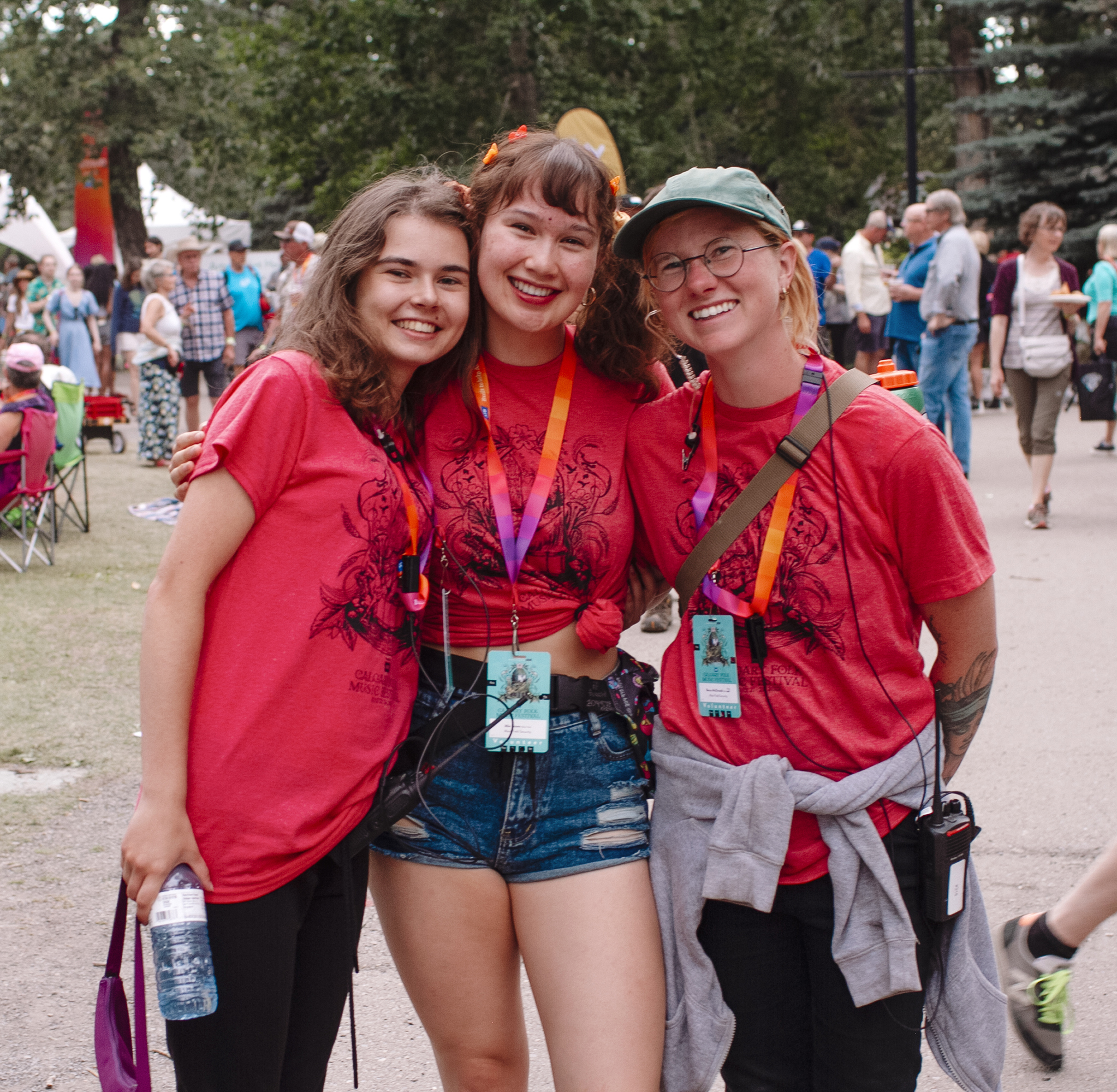 Volunteers smile and look into the camera at the 2022 Calgary Folk Music Festival.