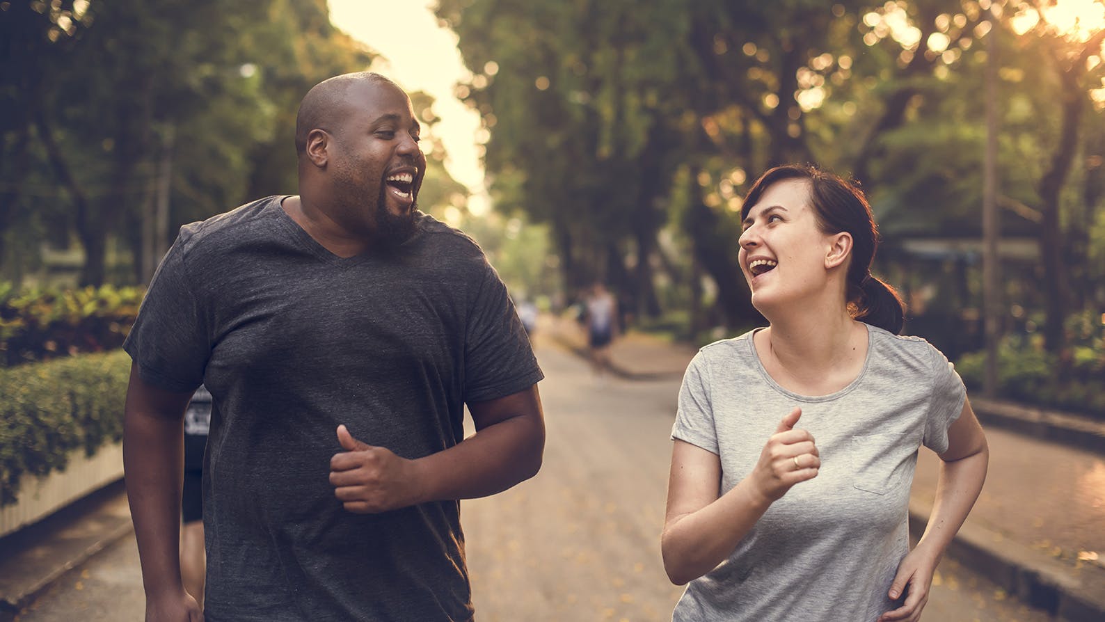 Two people running in a park